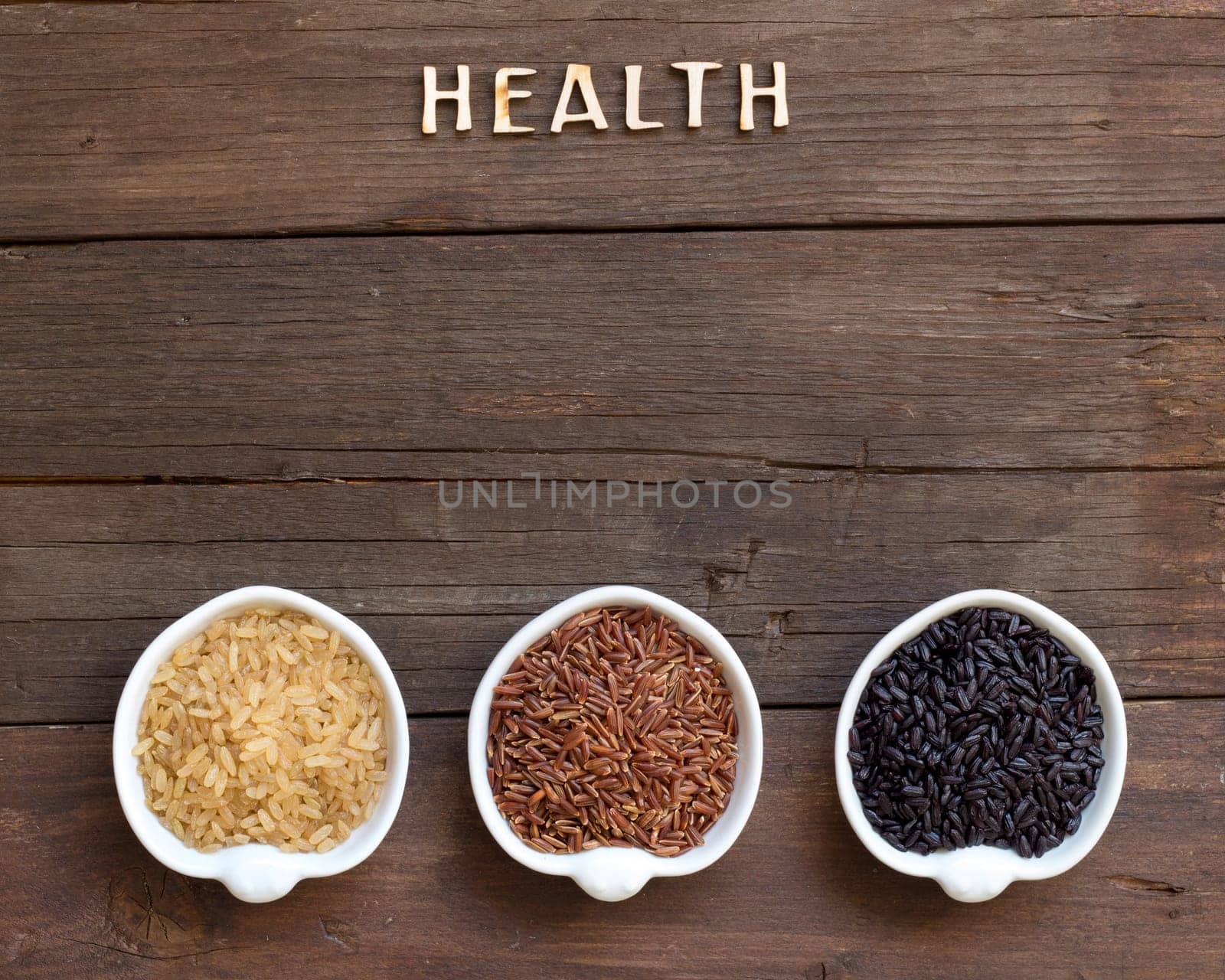 Variety of rice in bowls and word Health