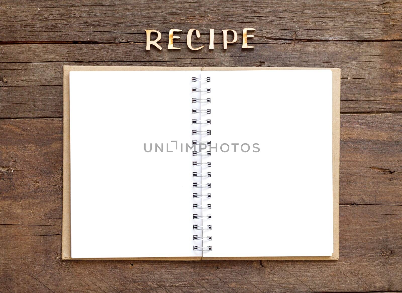 Recipes word with notebook on wooden background