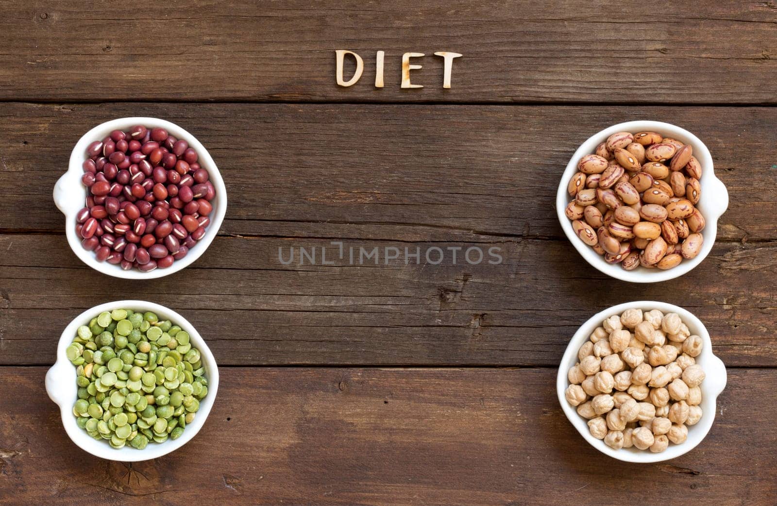 Legumes in bowls and the word Diet on wood