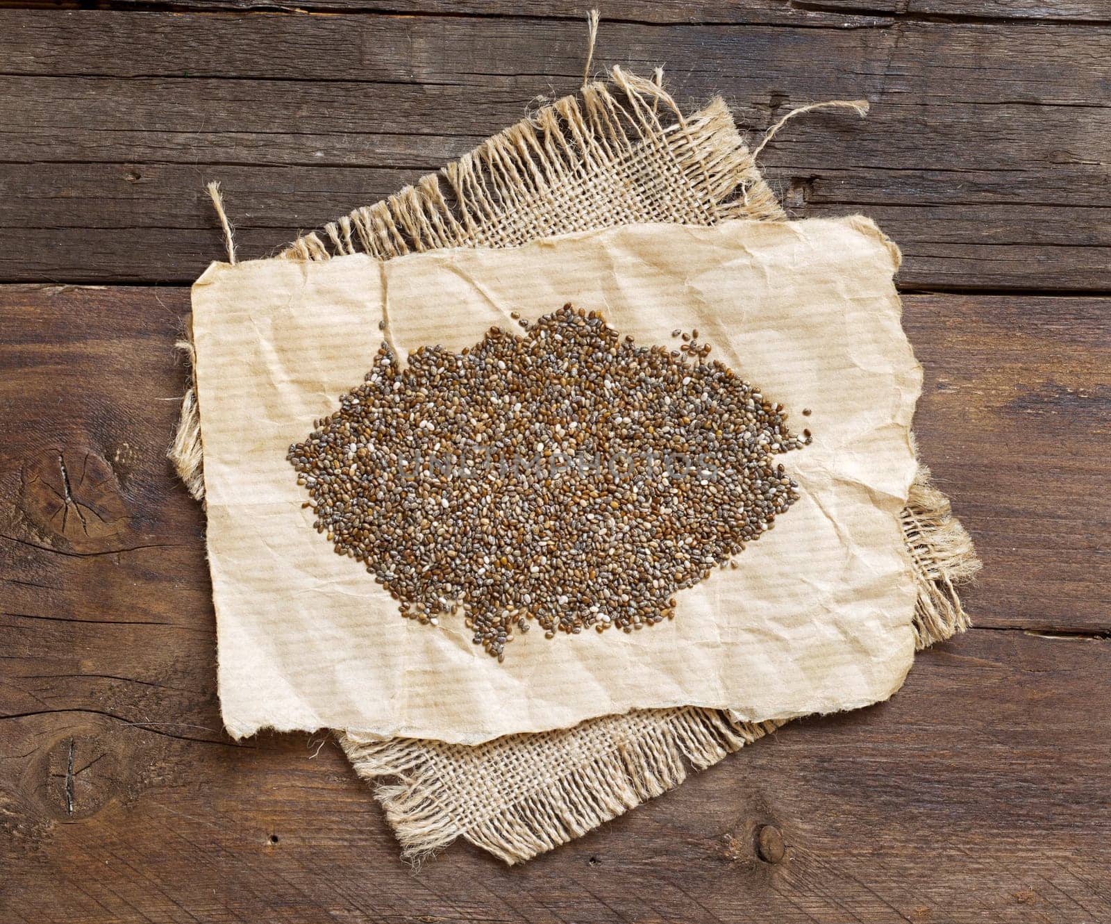 Pile of chia seeds on a rustic background