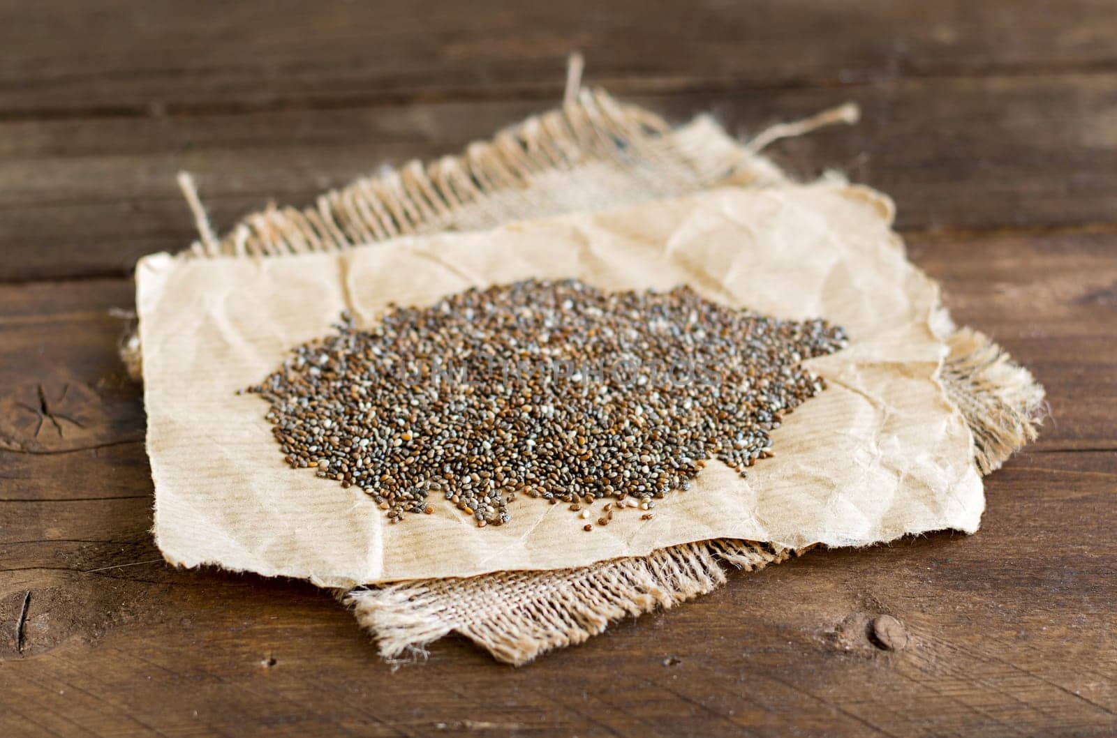 Pile of chia seeds on a rustic background