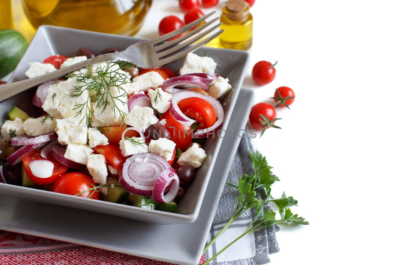 Greek salad with tomatoes, feta cheese, cucumbers, onions and olives