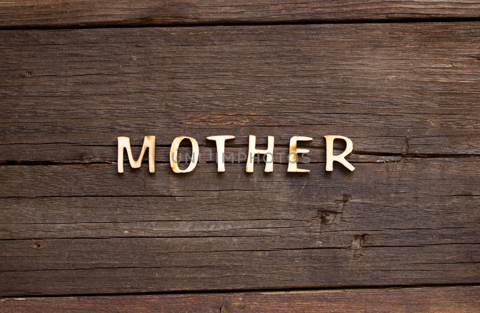 The word of Mother on a wooden background