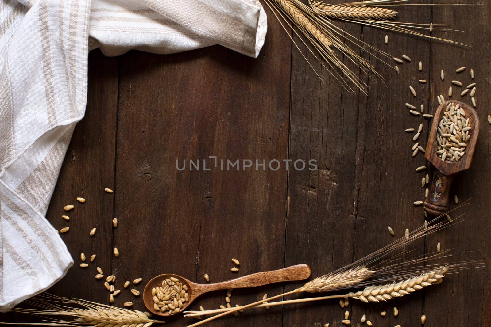 Wheat and spelt on an old wooden background