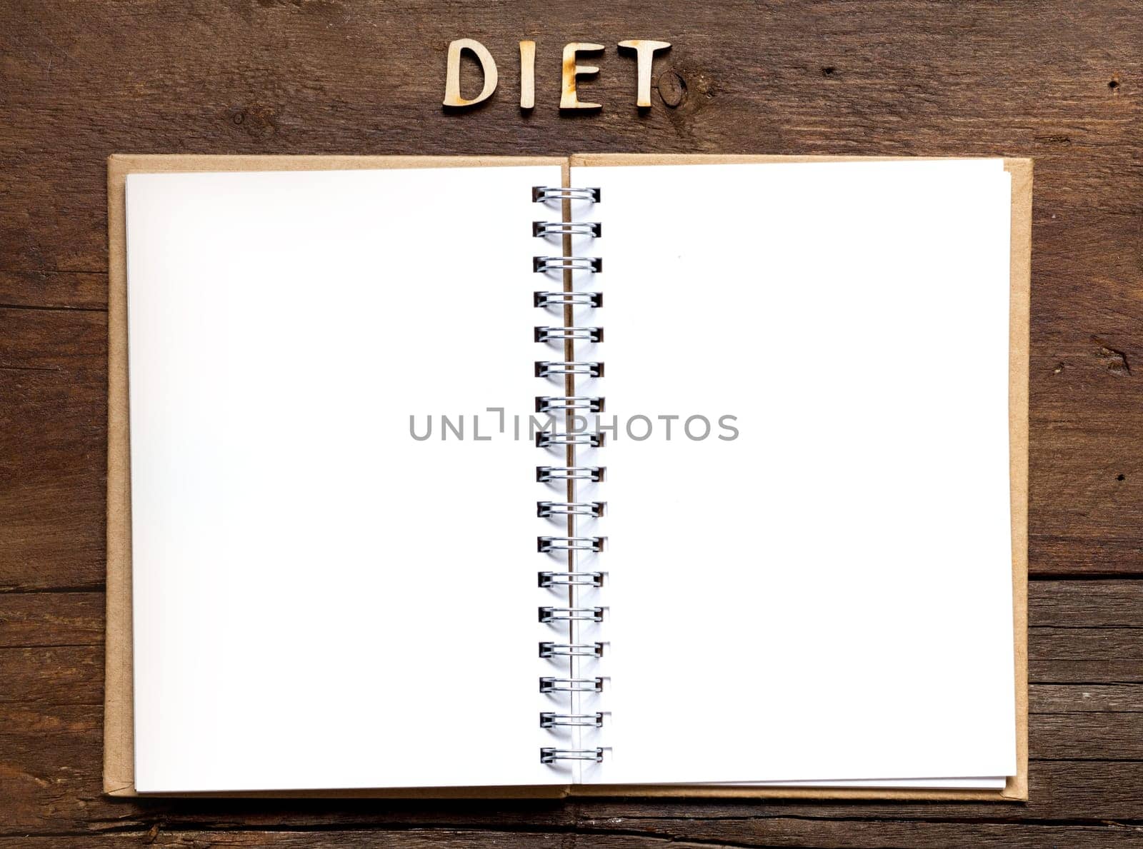 The word of Diet and notebook on wooden background