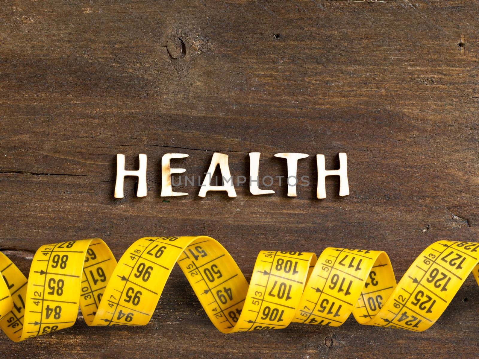 The word of Health on wood and measuring type on wooden background