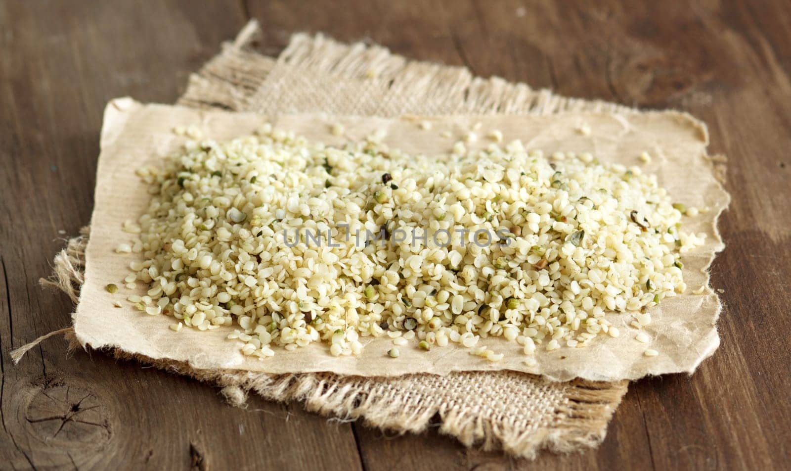 Raw organic hemp seeds on a wooden table