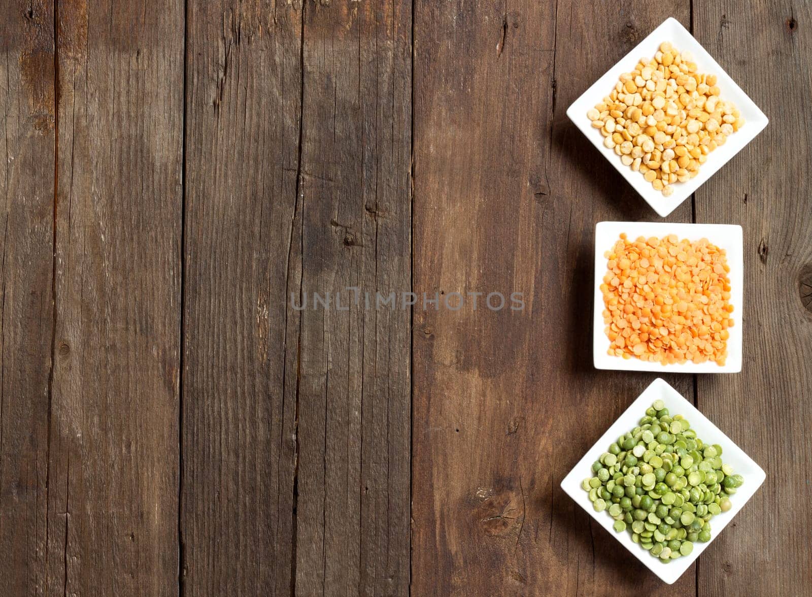 Legumes in bowls on a wooden table