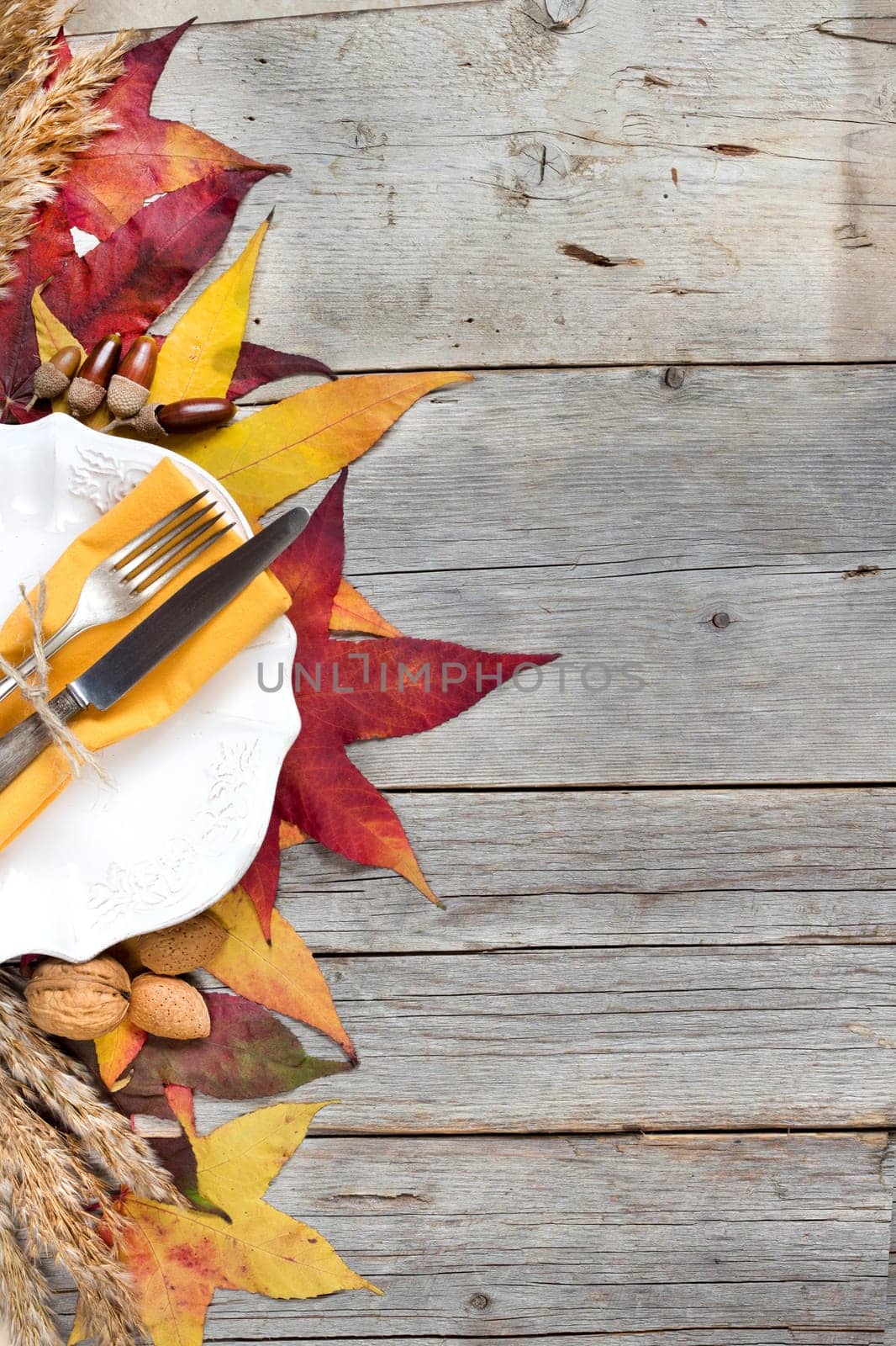 Autumn table setting with leaves, nuts and acorns