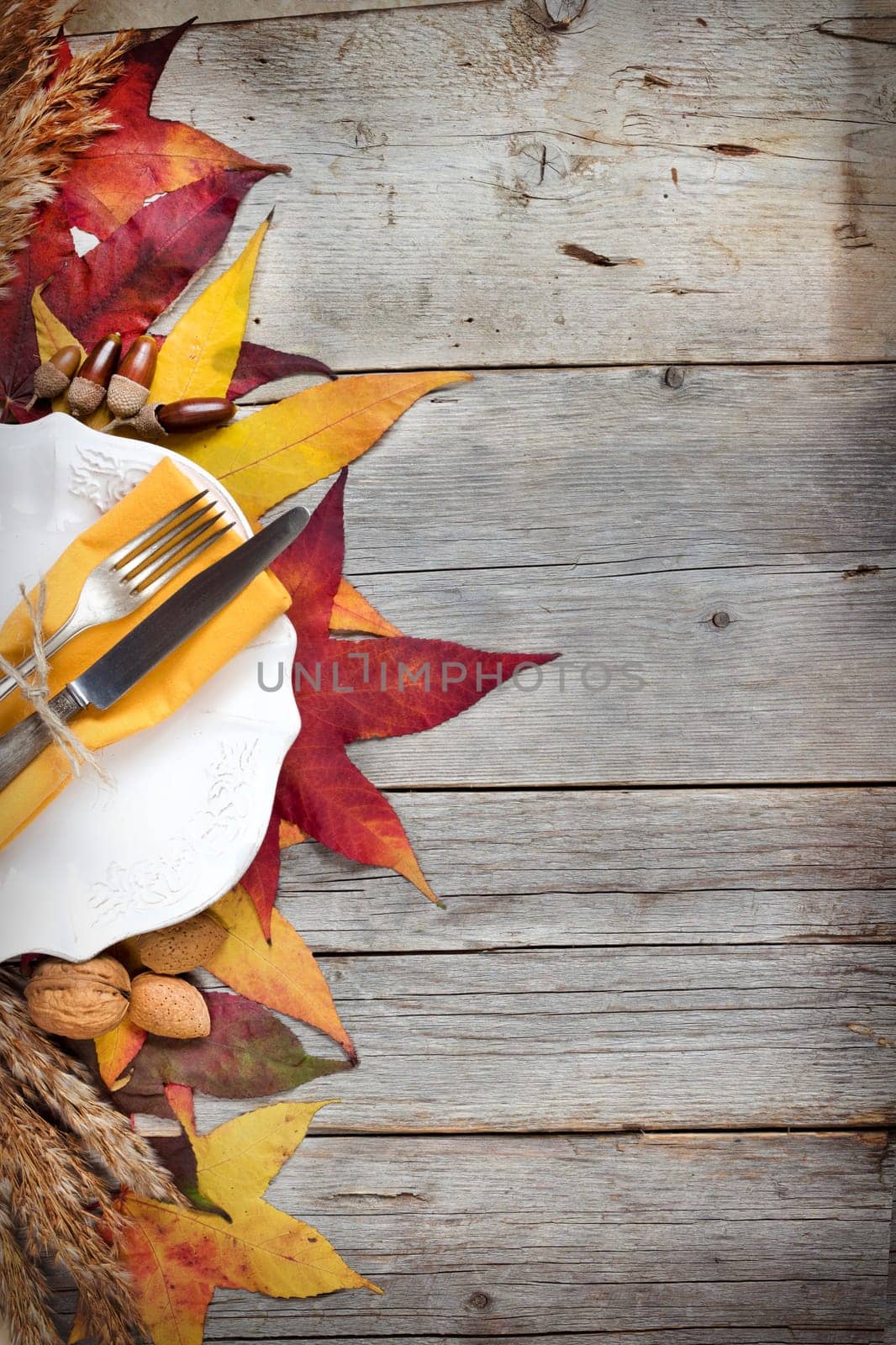 retro autumn table setting with leaves, nuts and acorns