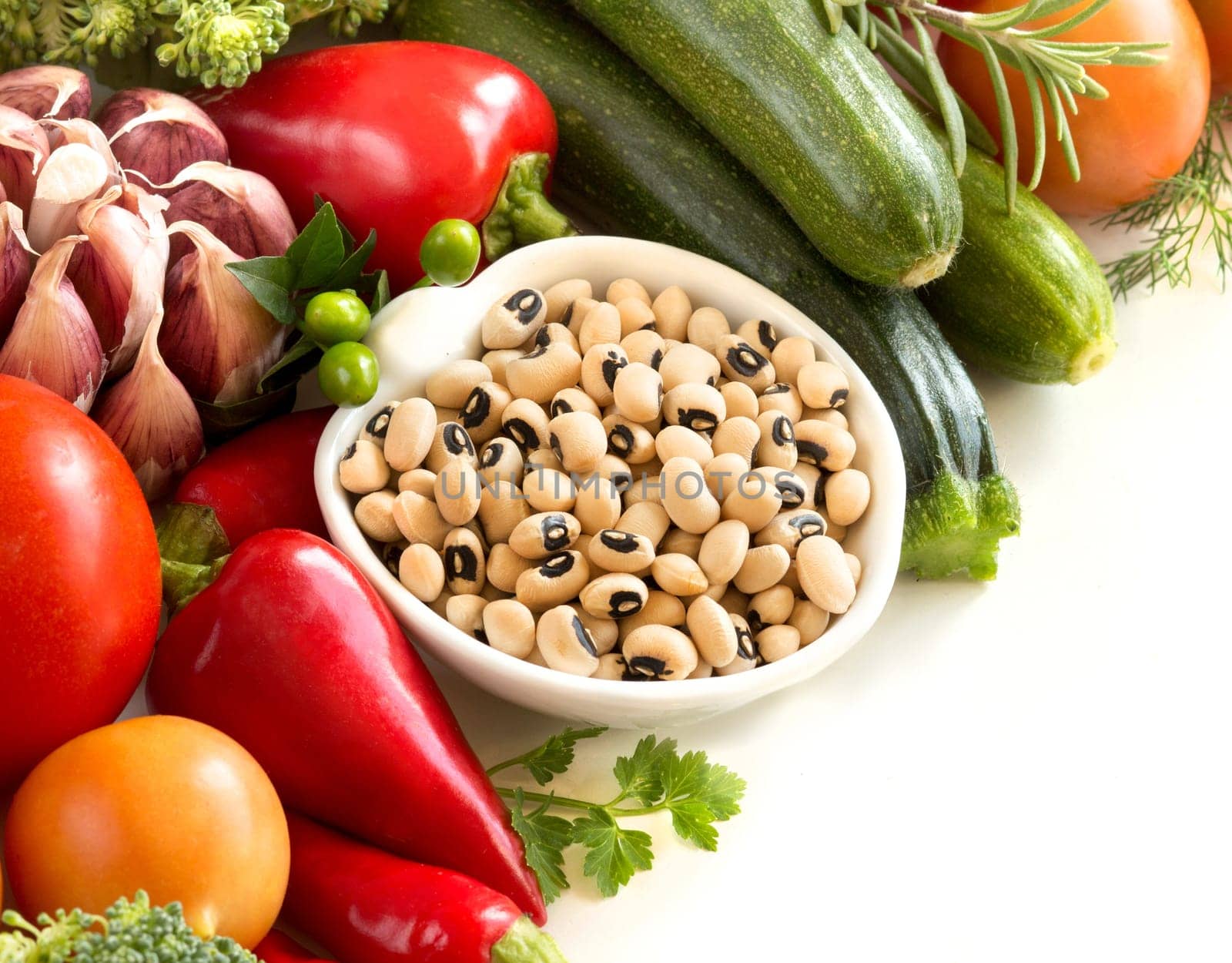 Black eyed peas in a bowl and vegetables