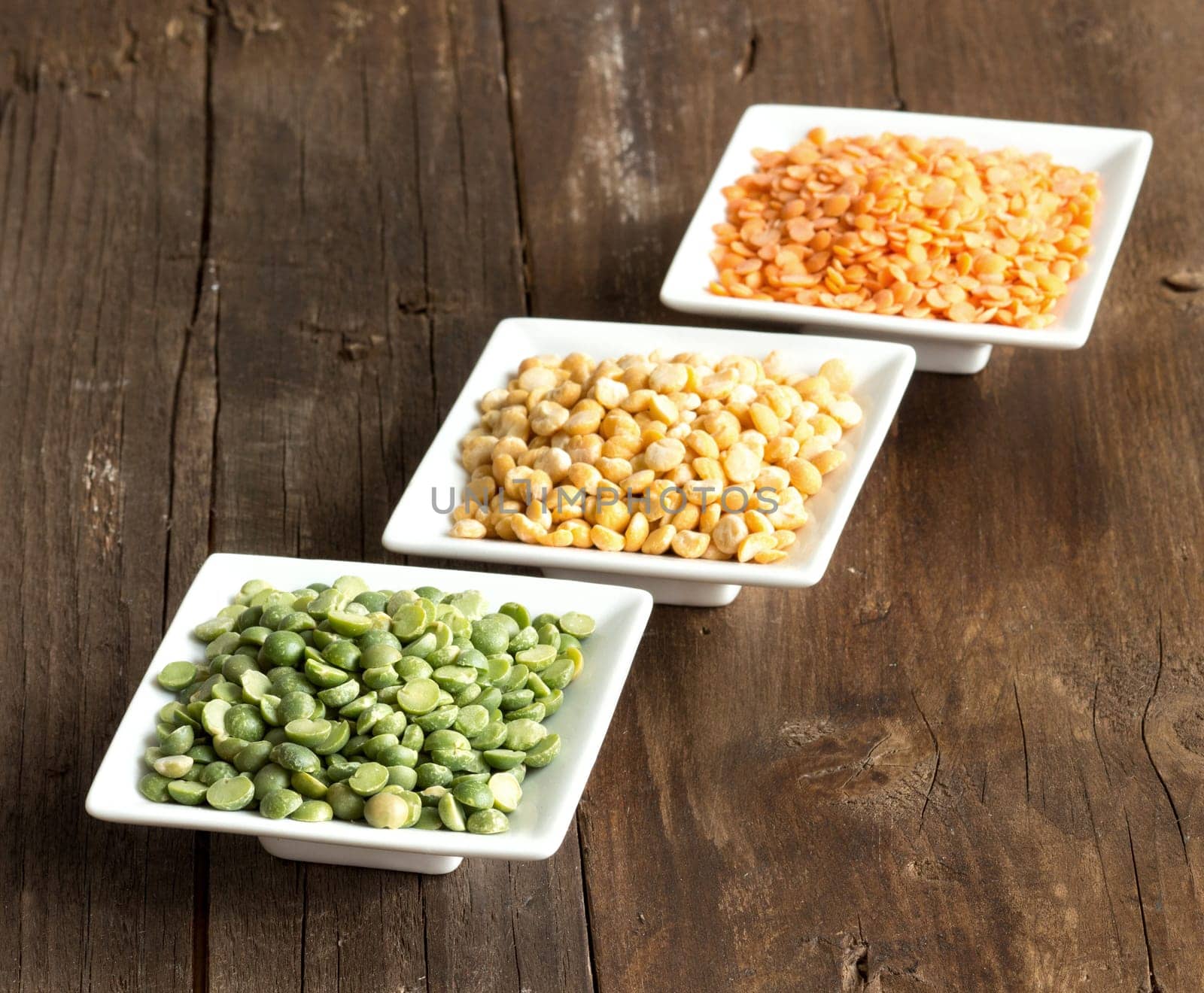 Legumes in bowls on a wooden table