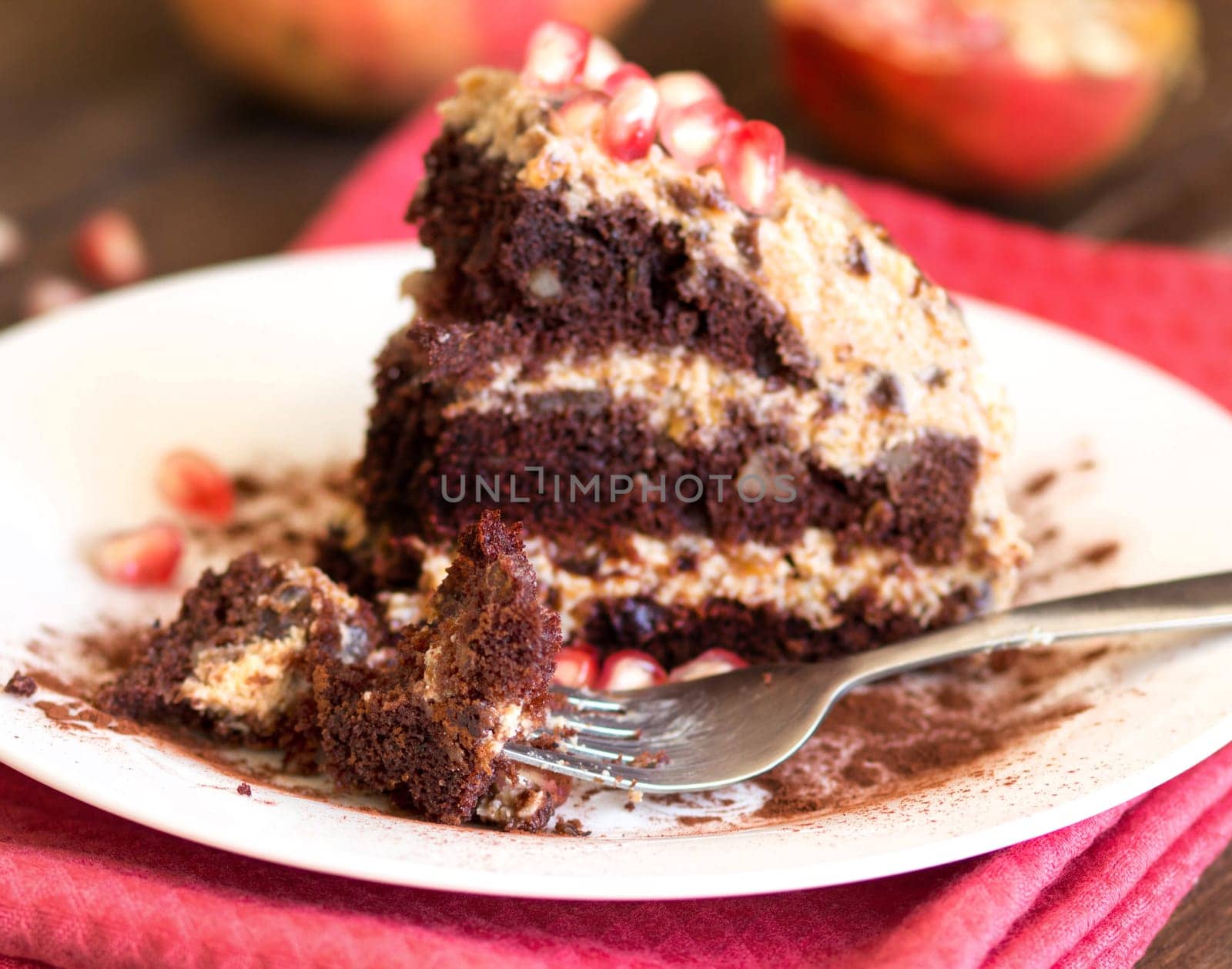 Chocolate, walnut and Prune Cake decorated with pomegranate seeds