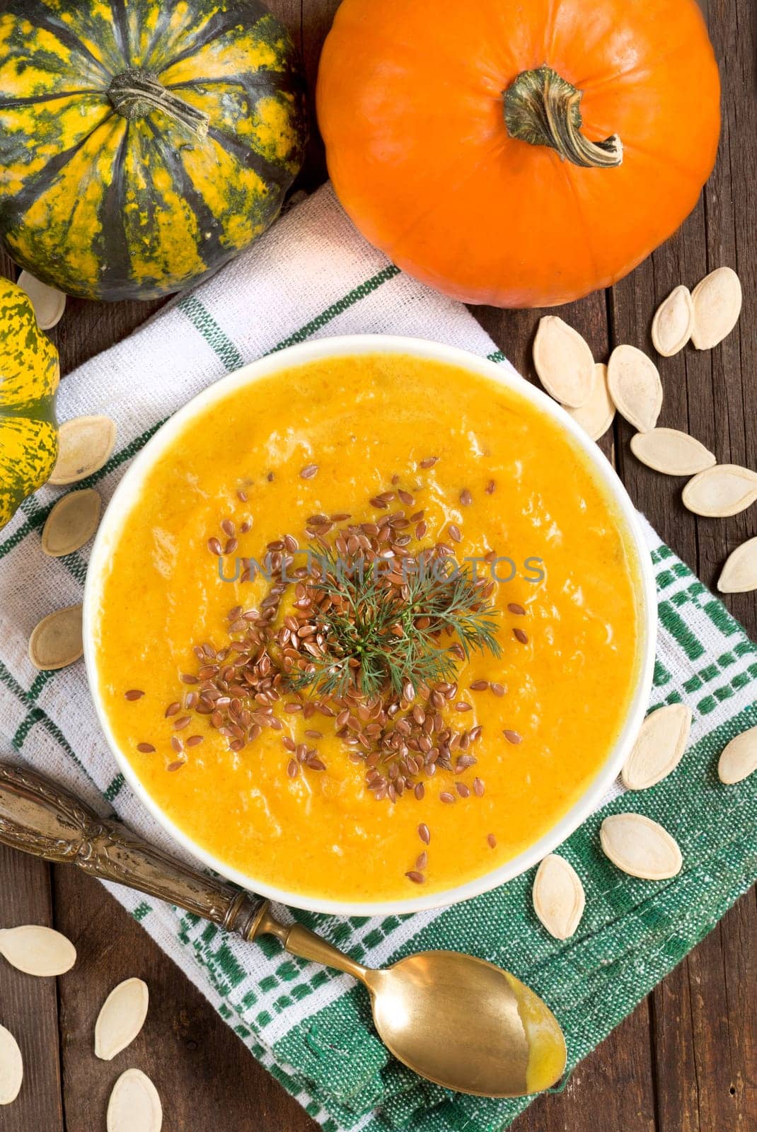 Pumpkin soup and pumpkins on a napkin