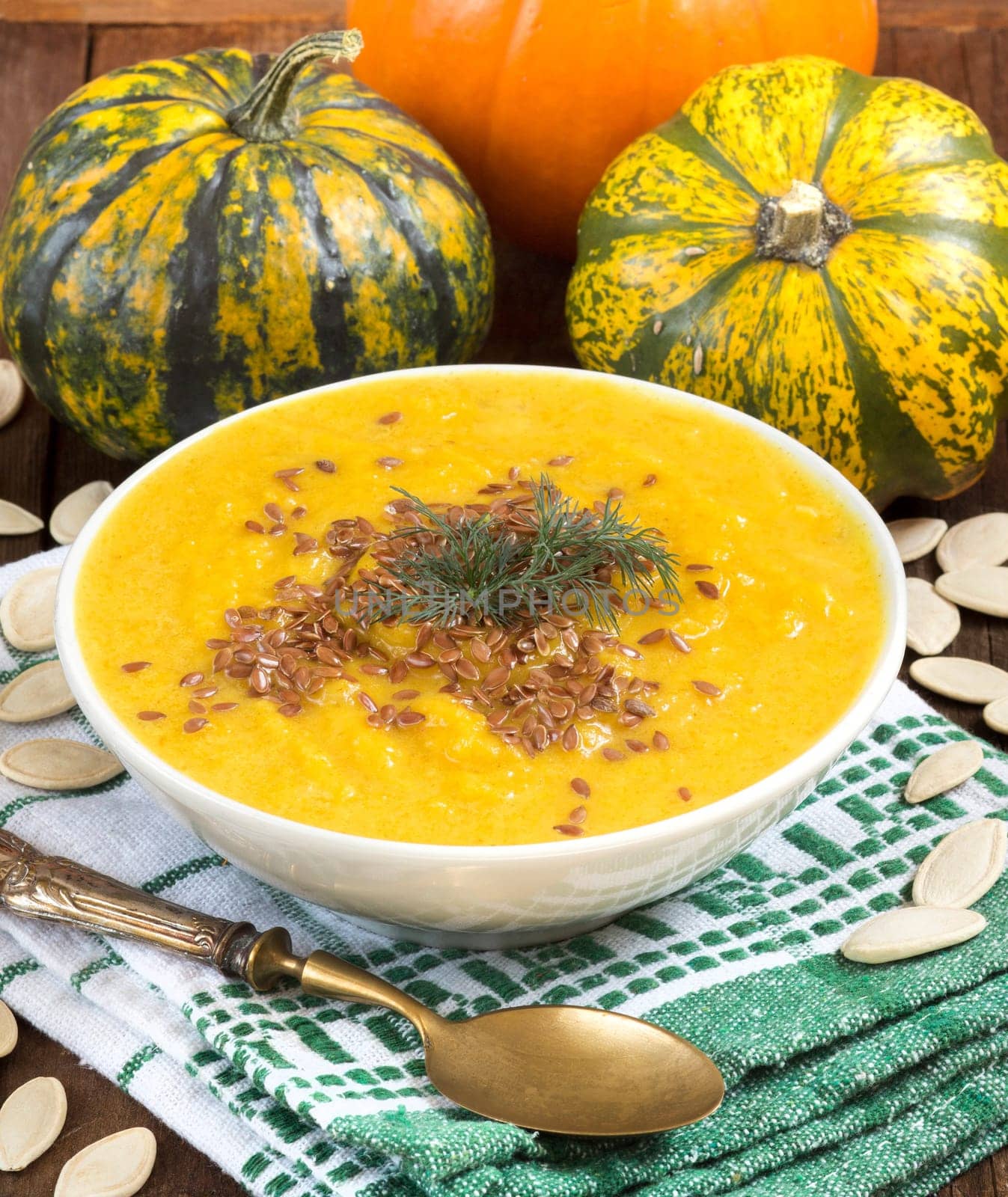 Pumpkin soup and pumpkins on a napkin
