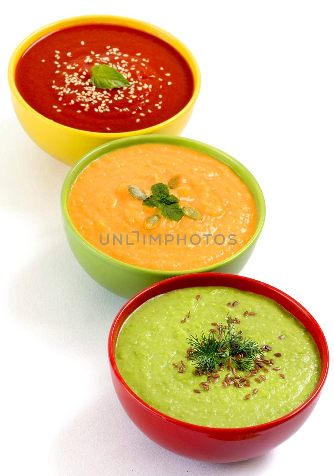Three fresh soups - tomatoe, pumpkin and green peas soups