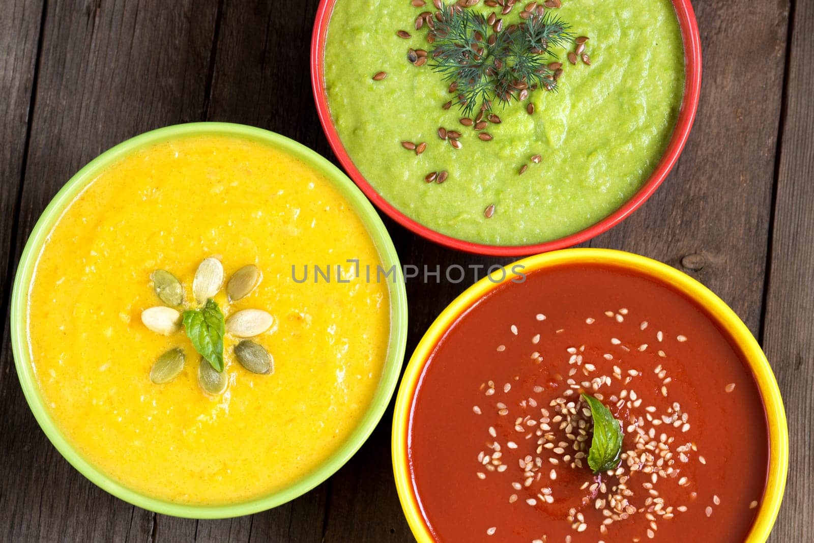 Three fresh soups - tomatoes, pumpkin and green peas soups