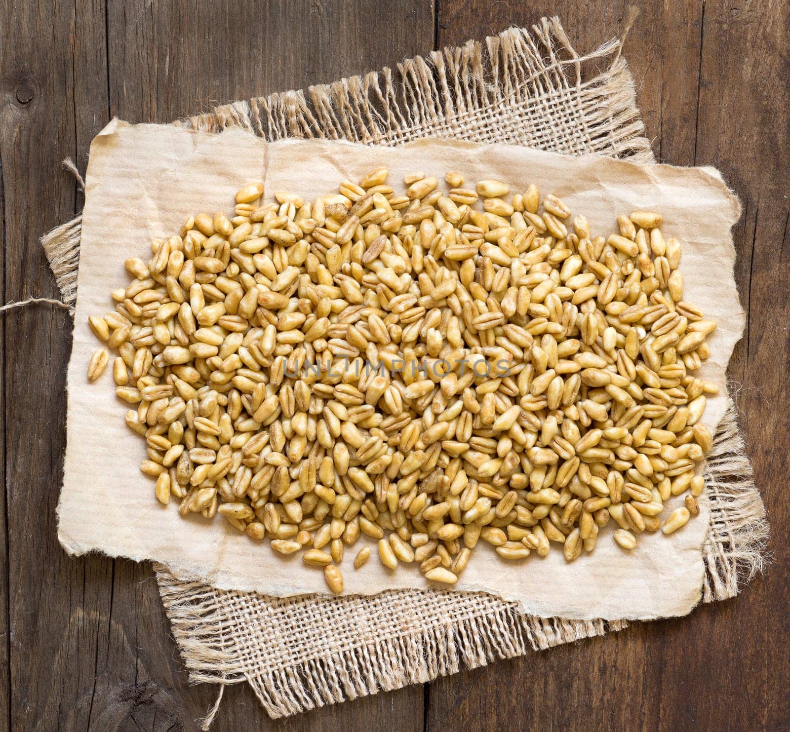 Raw organic spelt on a wooden table