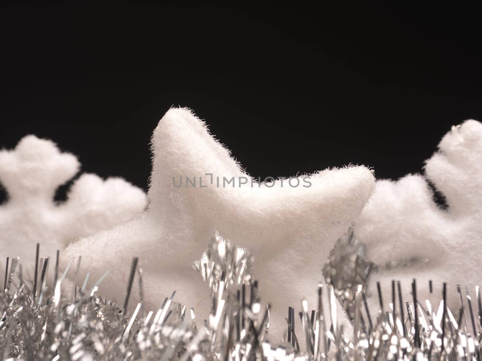 Closeup of a star shape and snowflake on a dark background