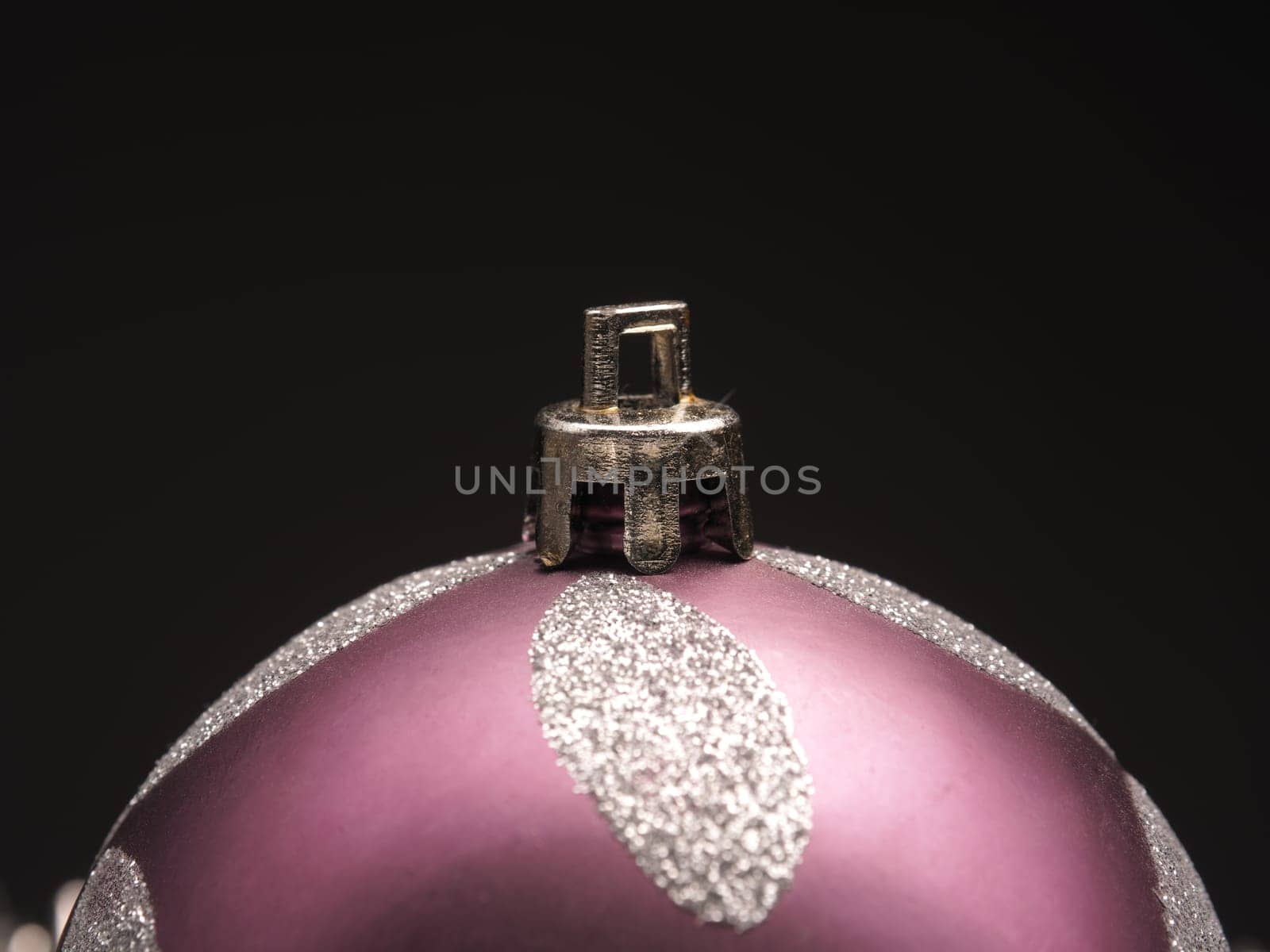 Closeup of a Christmas bauble on a dark background with space for text