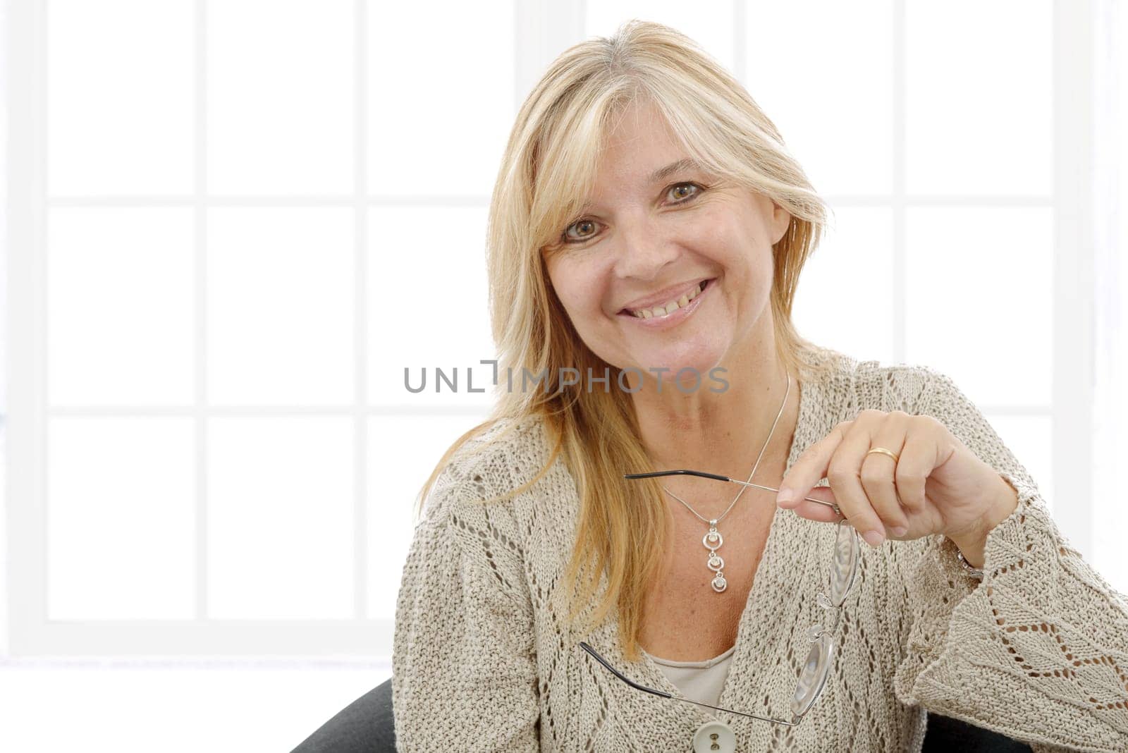 a portrait of mature smiling blond woman
