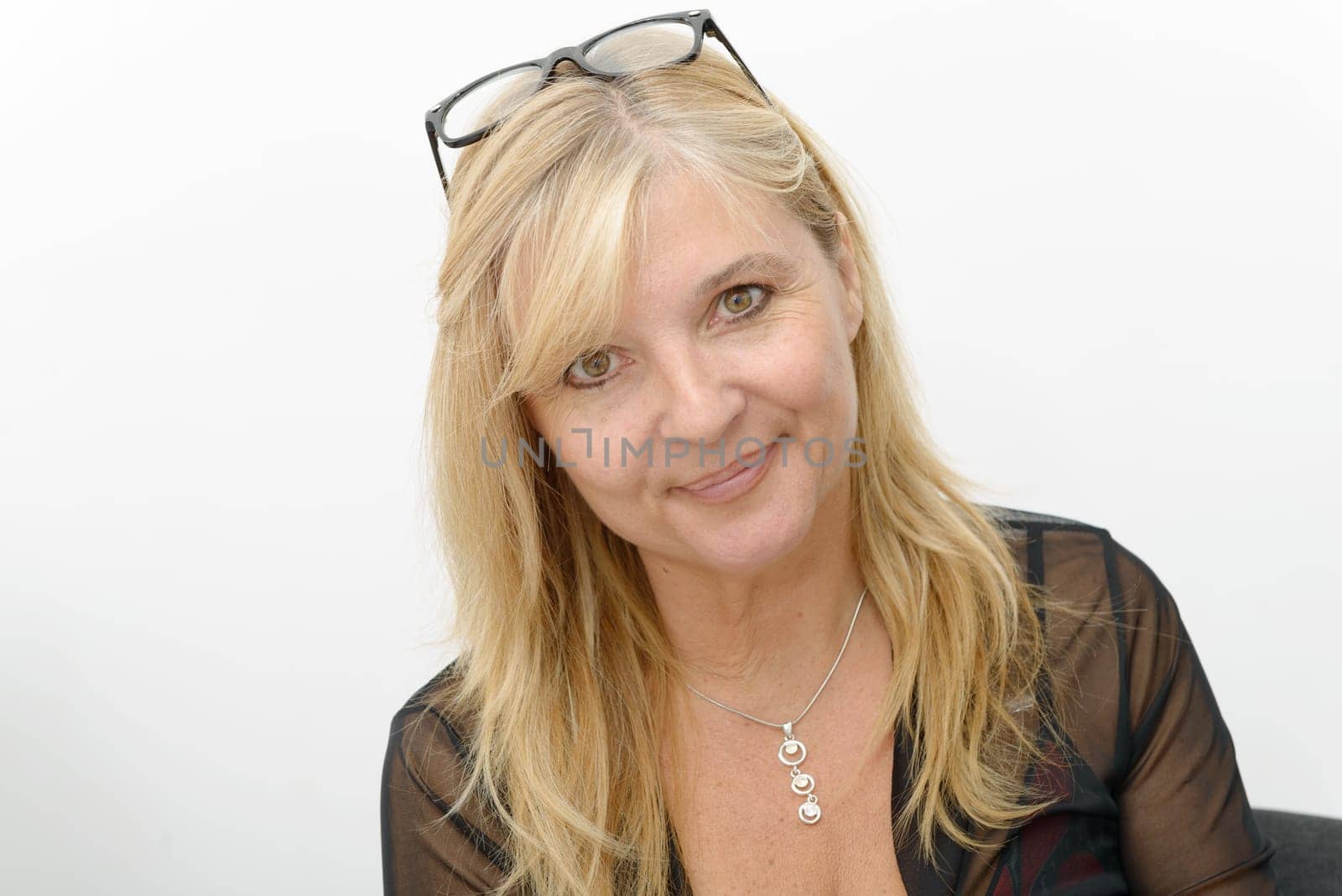 a portrait of mature smiling blond woman