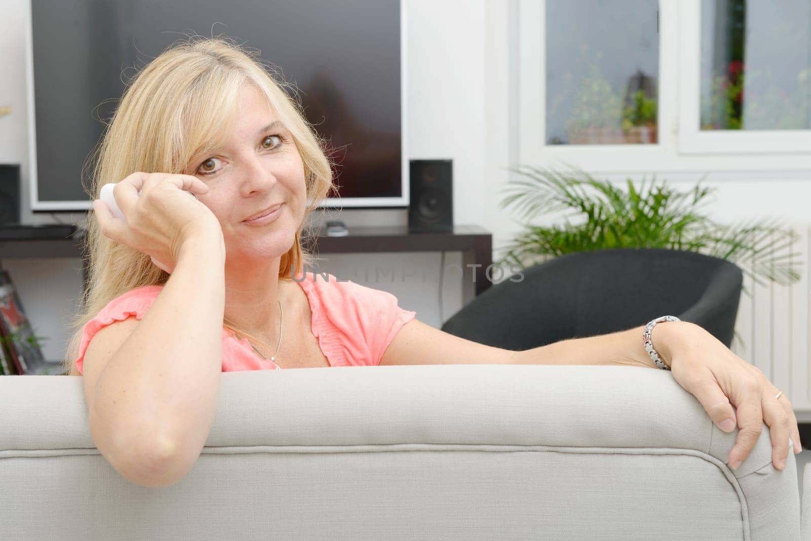 a mature blond woman talking on mobile phone