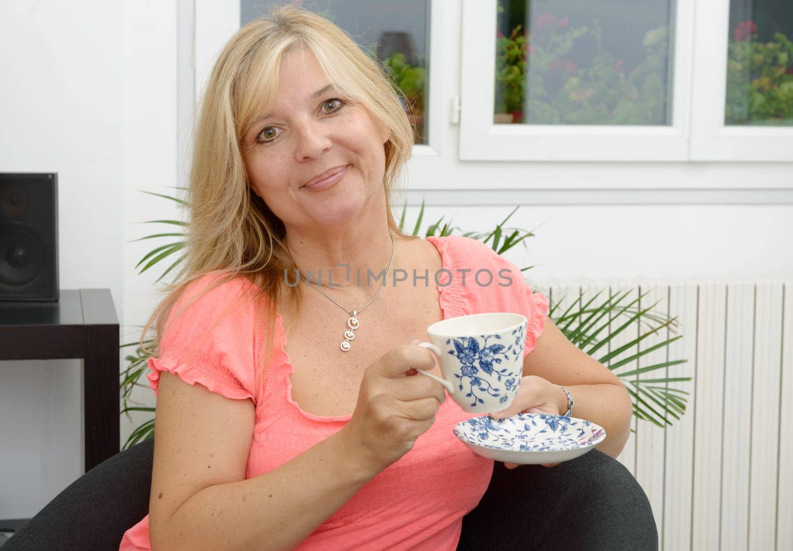 Smiling senior woman drinking tea at home