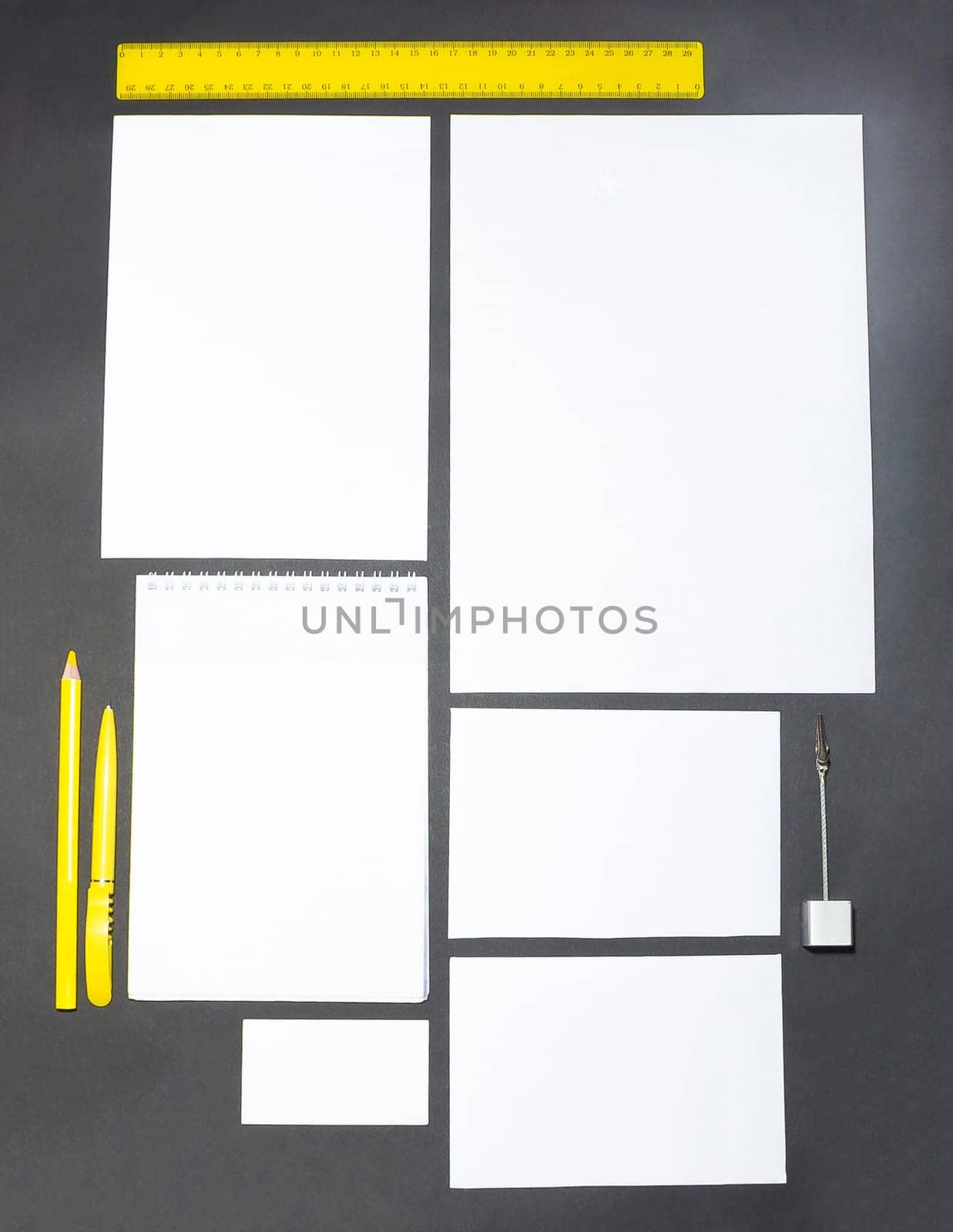 Mock-up business template with cards, papers, pen on gray background.