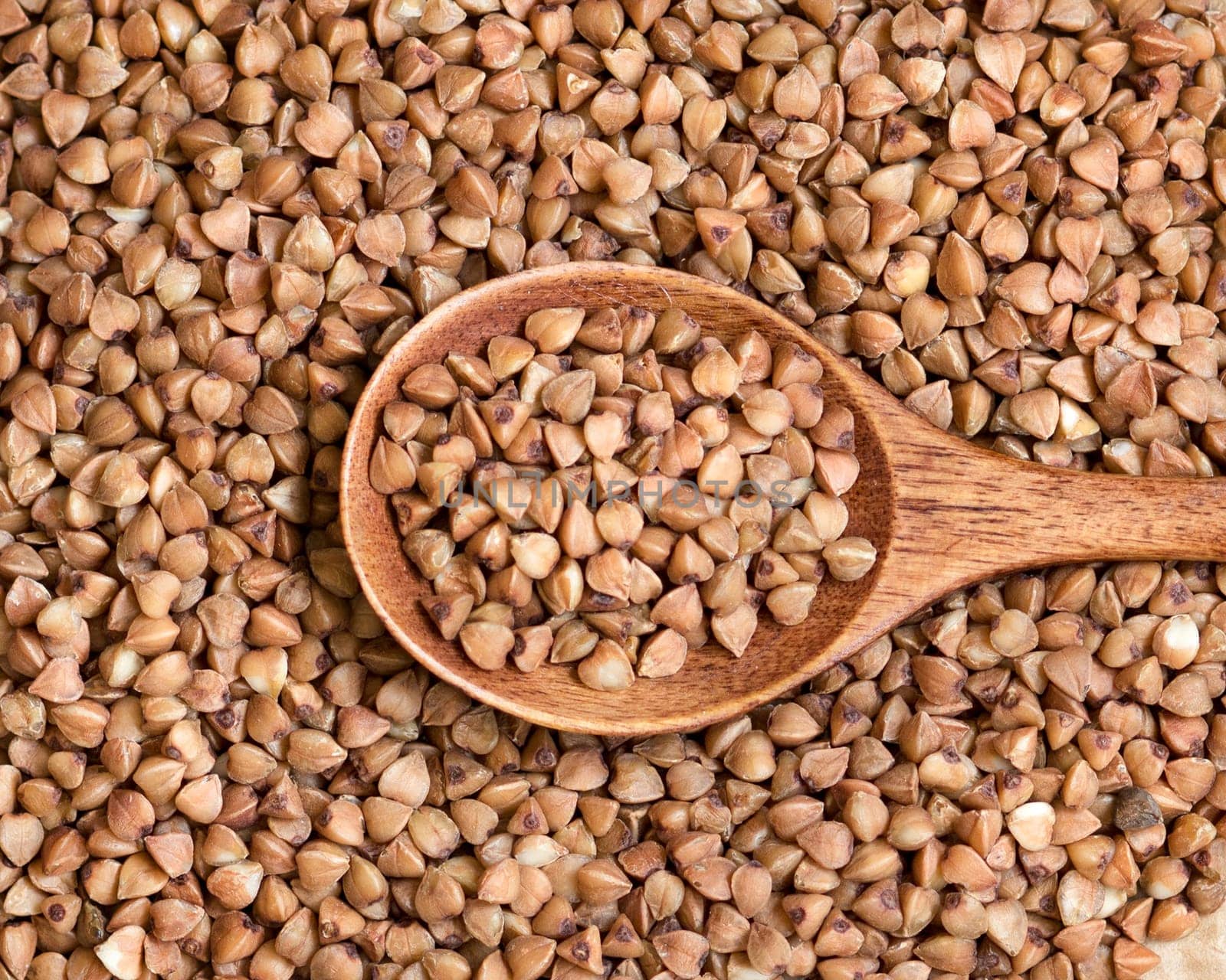 Buckwheat and a spoon close up background