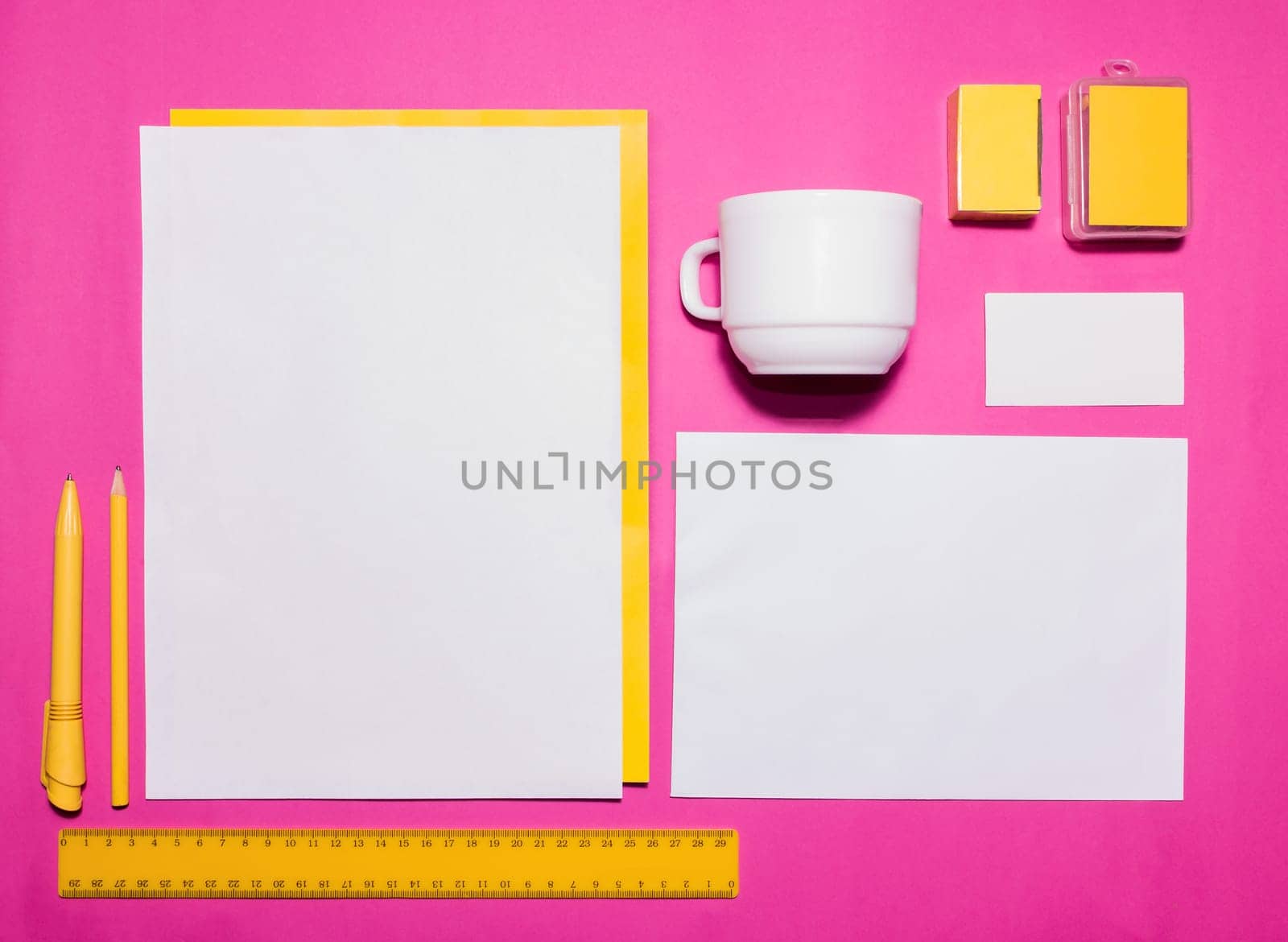 Mock-up business template with cards, papers, pen on pink background.