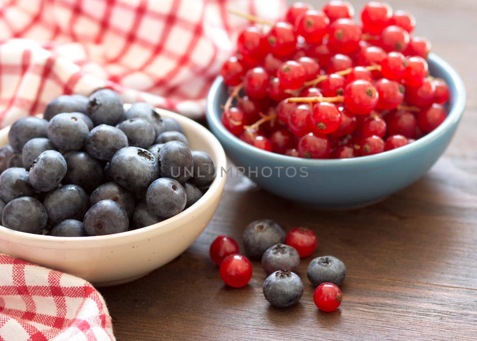 Fresh berries - blueberries and red currants in bowls