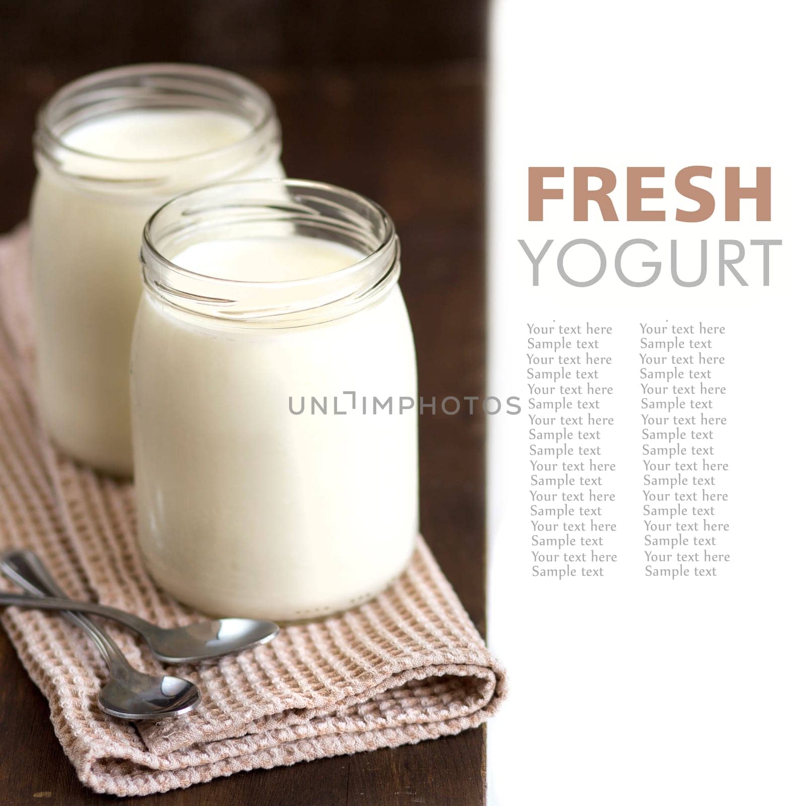 Jars of fresh natural yogurt with spoons on wooden background