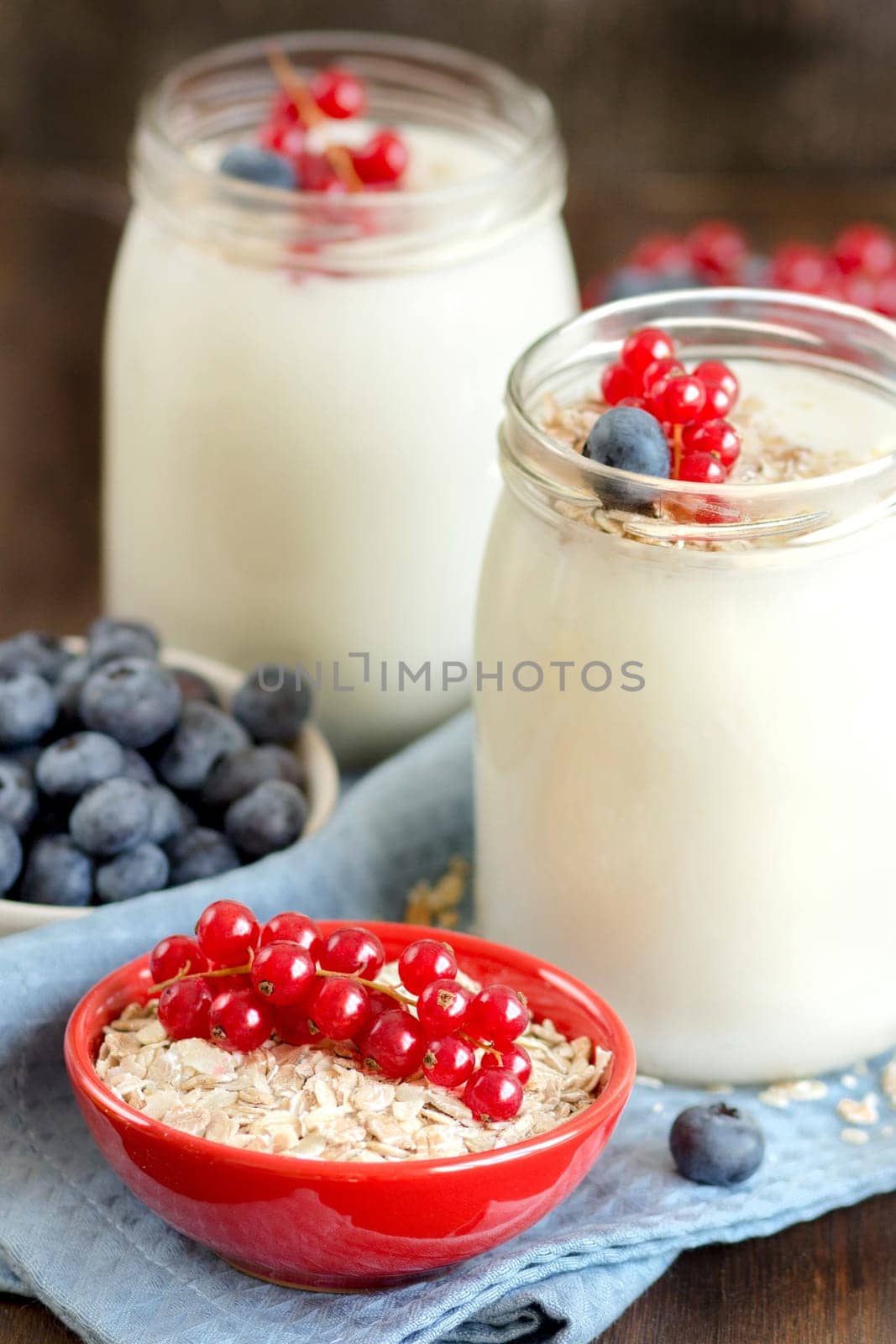Jars of fresh natural yogurt, berries and cereals