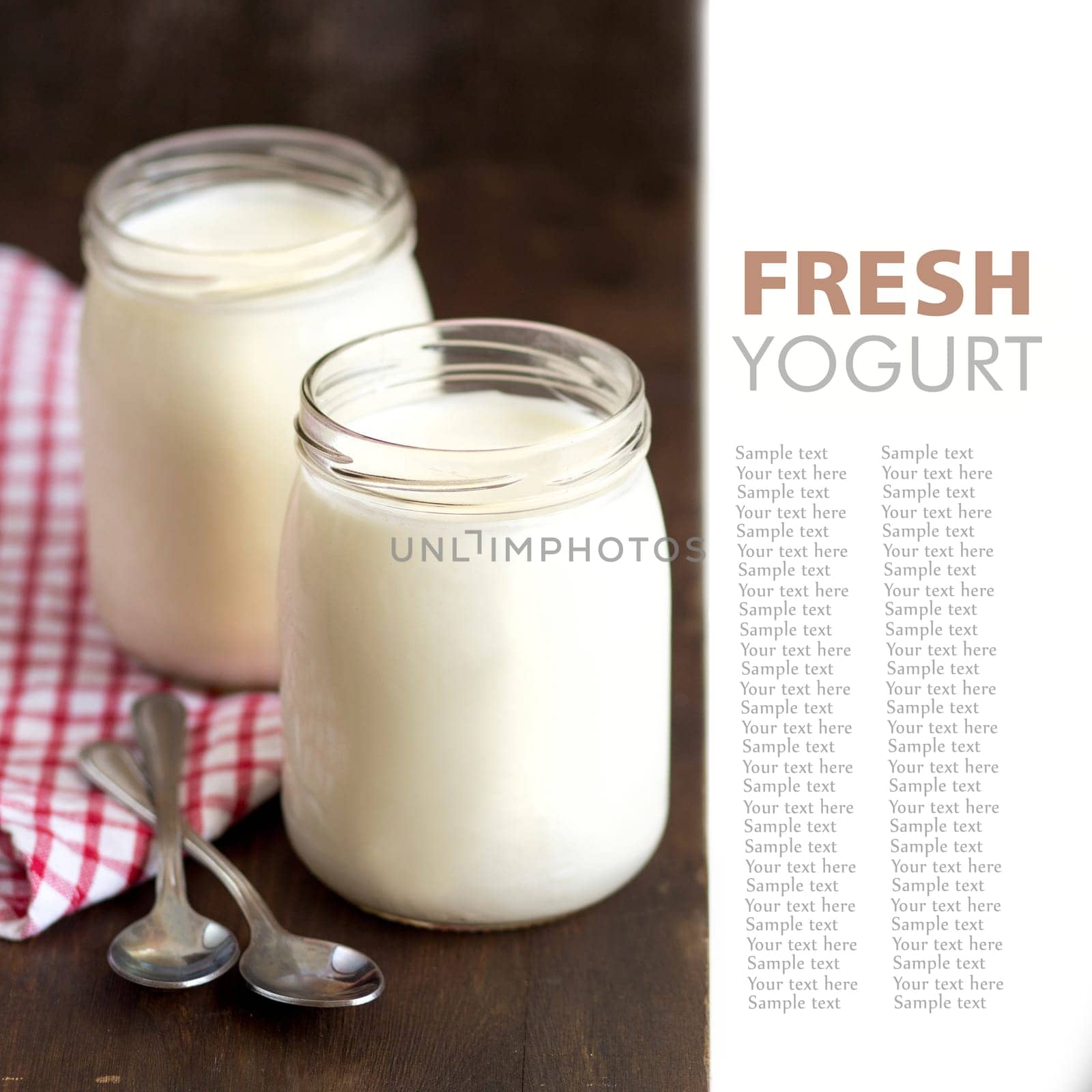 Jars of fresh natural yogurt and two spoons
