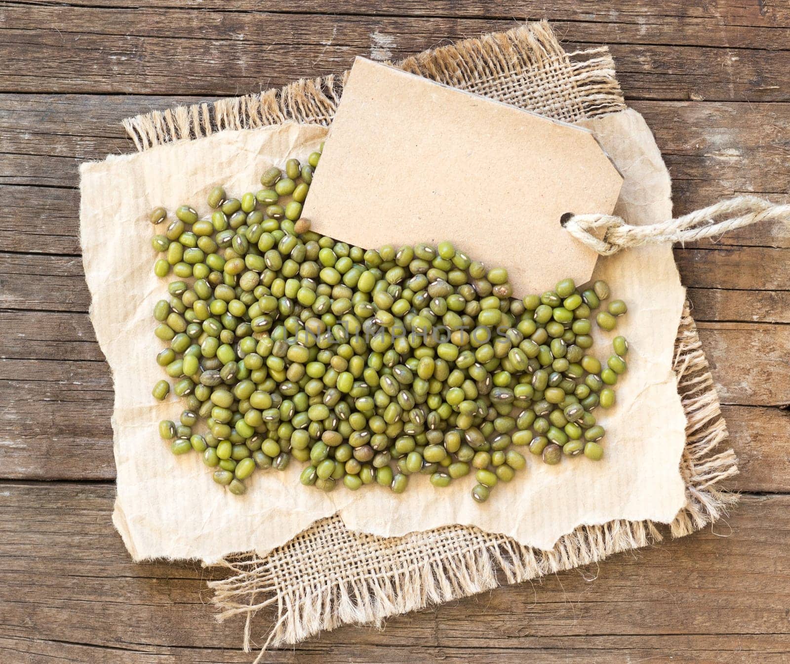 Mung beans and paper label on a wooden table