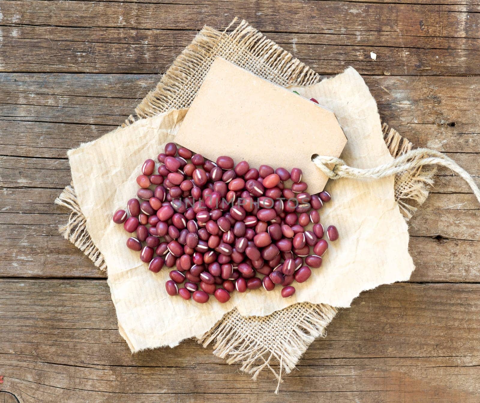 Azuki beans and paper label on a wooden table