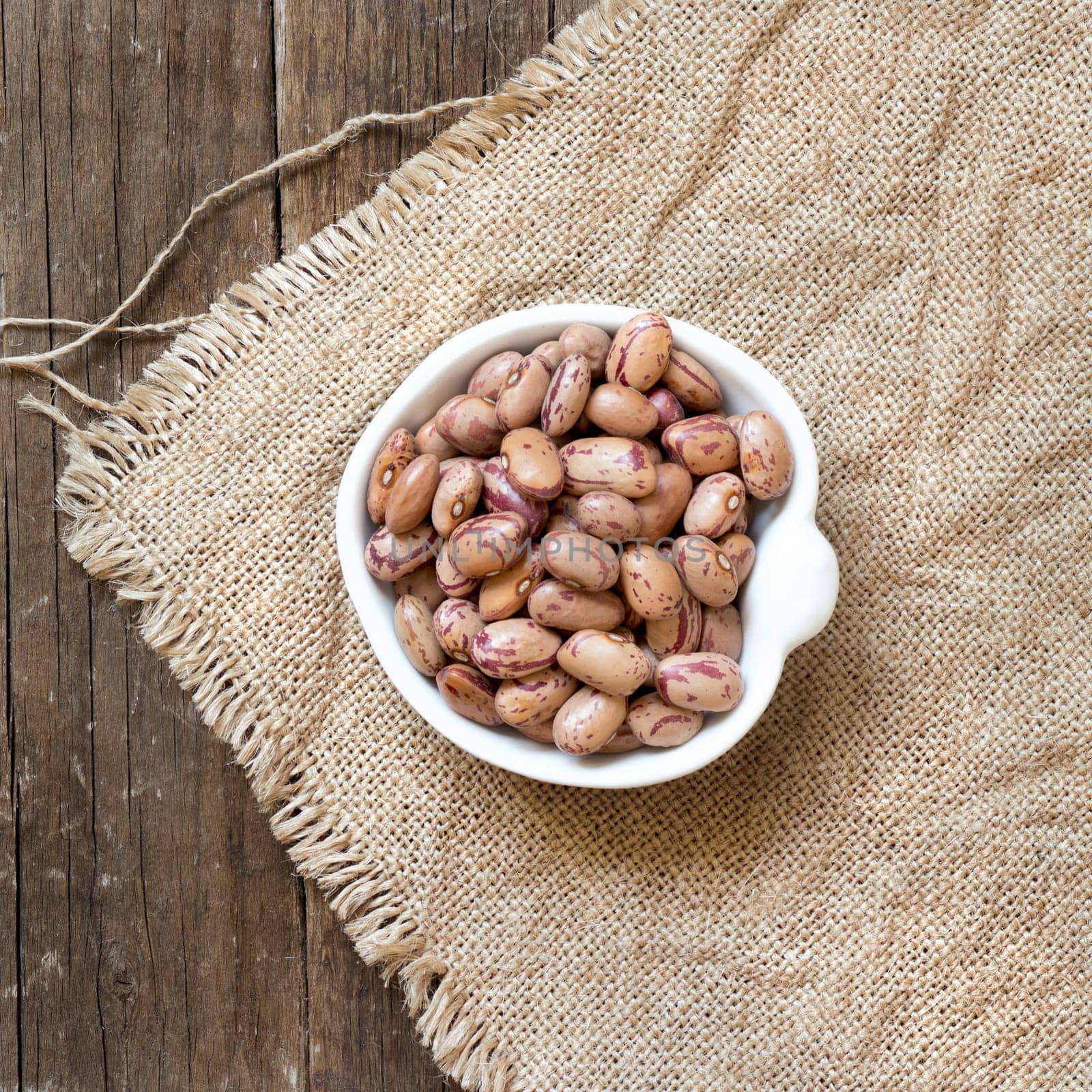 Pinto beans in a bowl on burlap