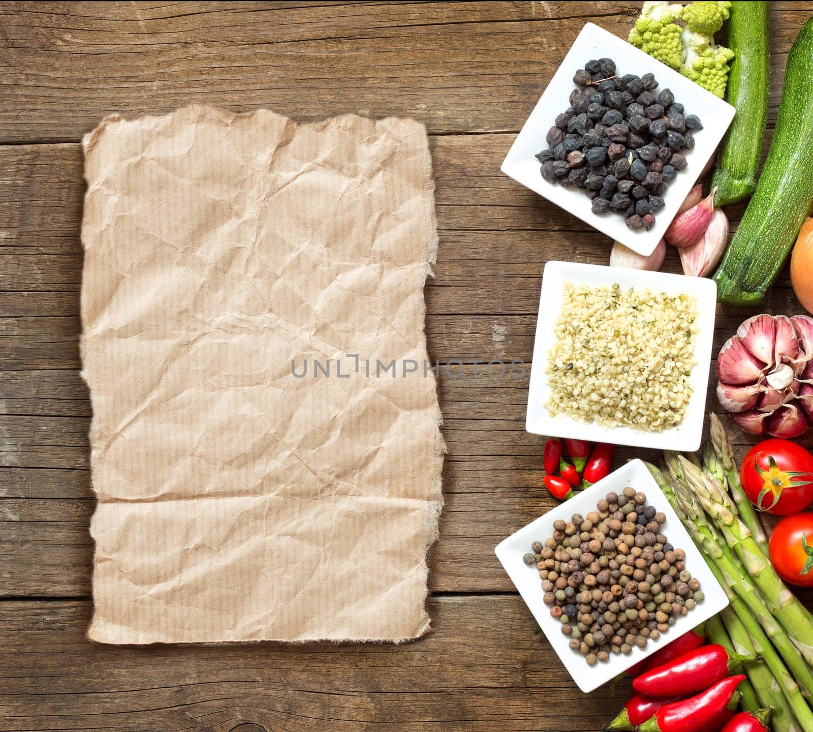 Roveja, hemp seeds, black chickpea and vegetables on a wooden table