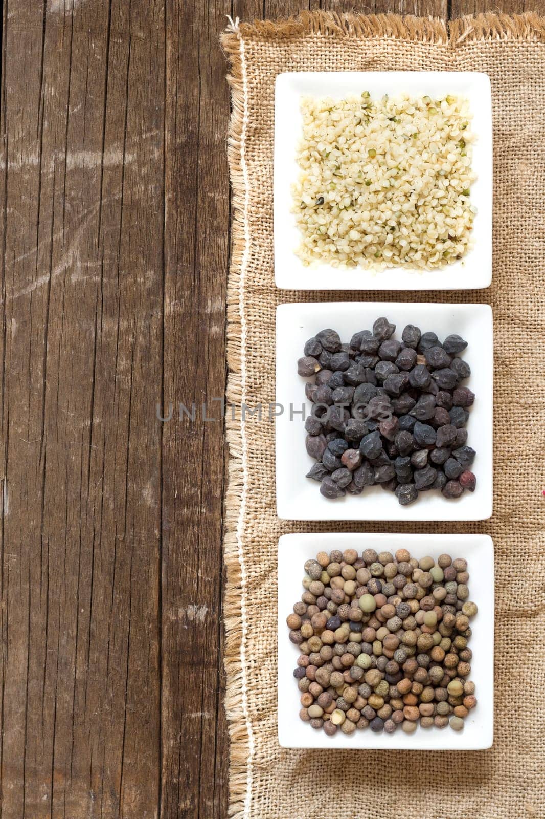 Roveja, hemp seeds and black chickpea on a wooden table