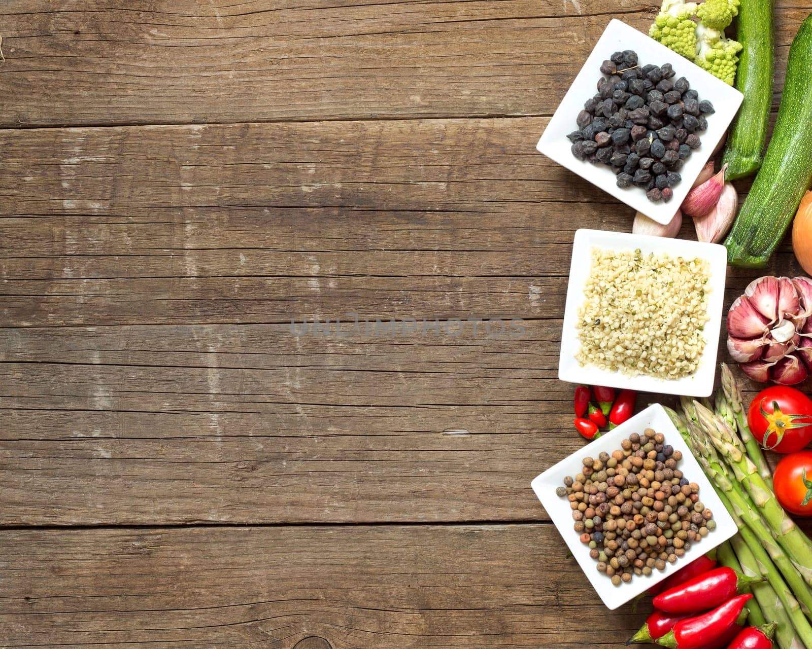 Roveja, hemp seeds, black chickpea and vegetables on a wooden table