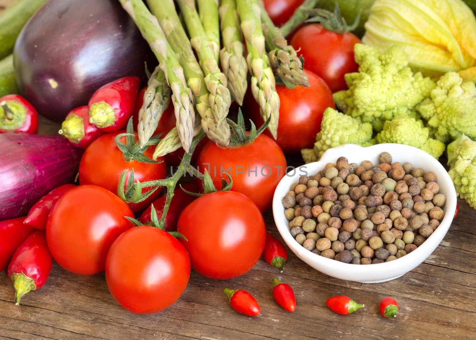 Raw organic roveja beans and vegetables on wooden table