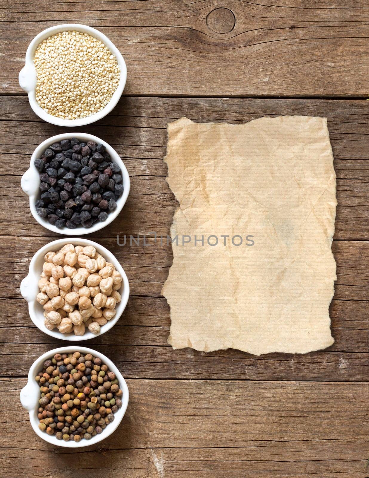 Cereals and legumes in bowls on a wooden table