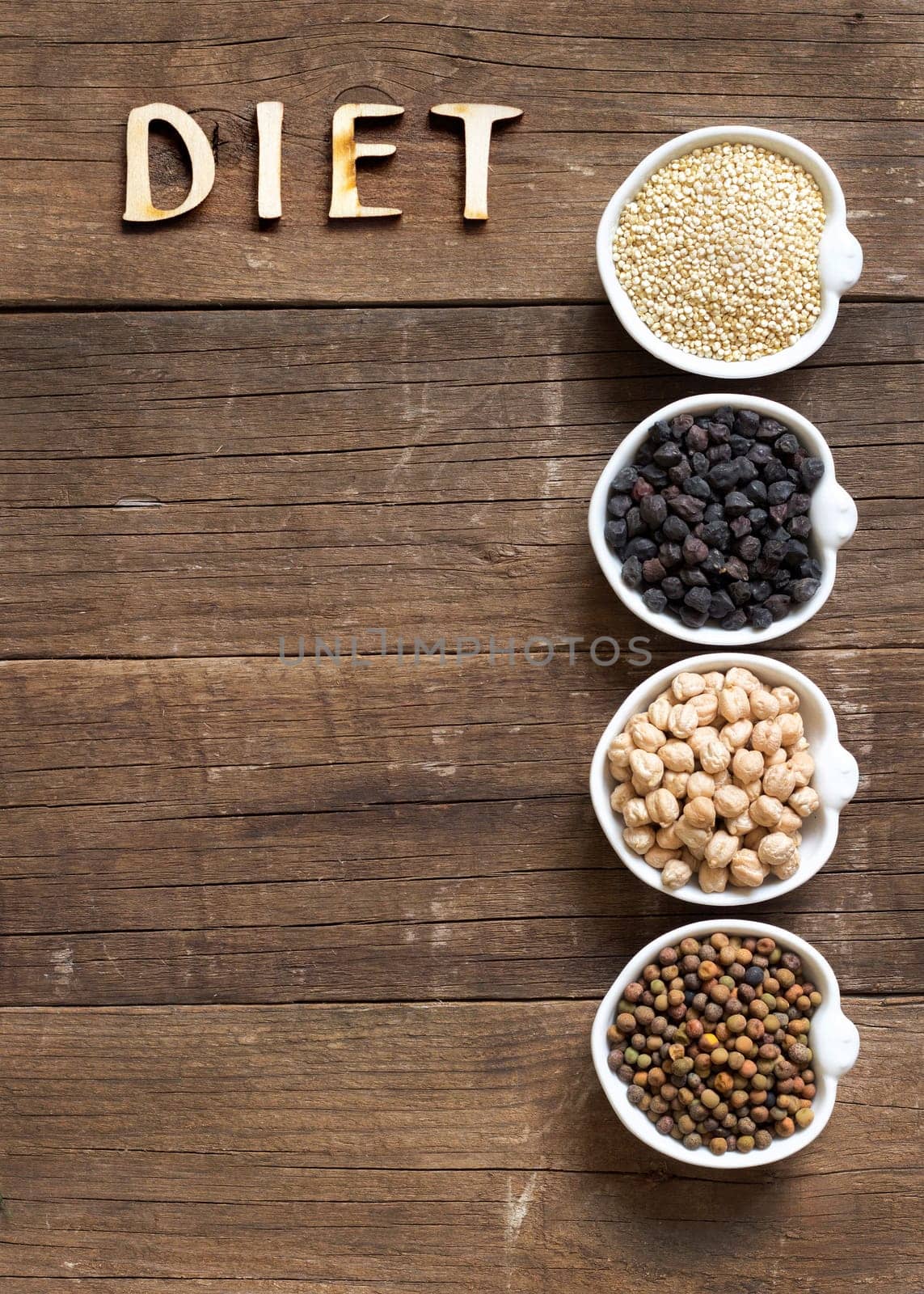 Cereals and legumes in bowls on a wooden table