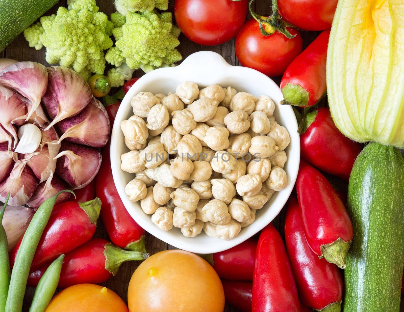 Dried organic chickpea in a bowl and vegetables