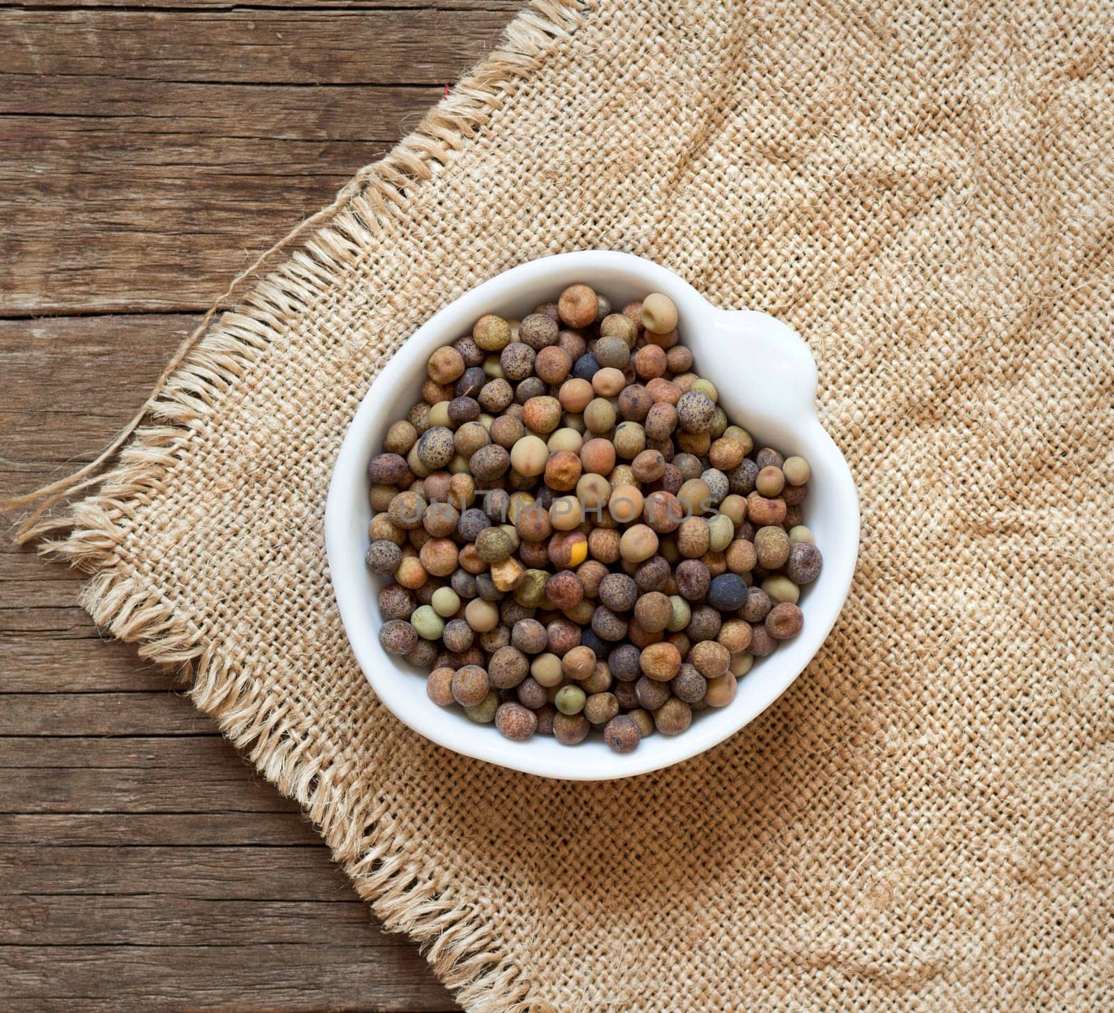 Raw organic roveja beans on wooden table