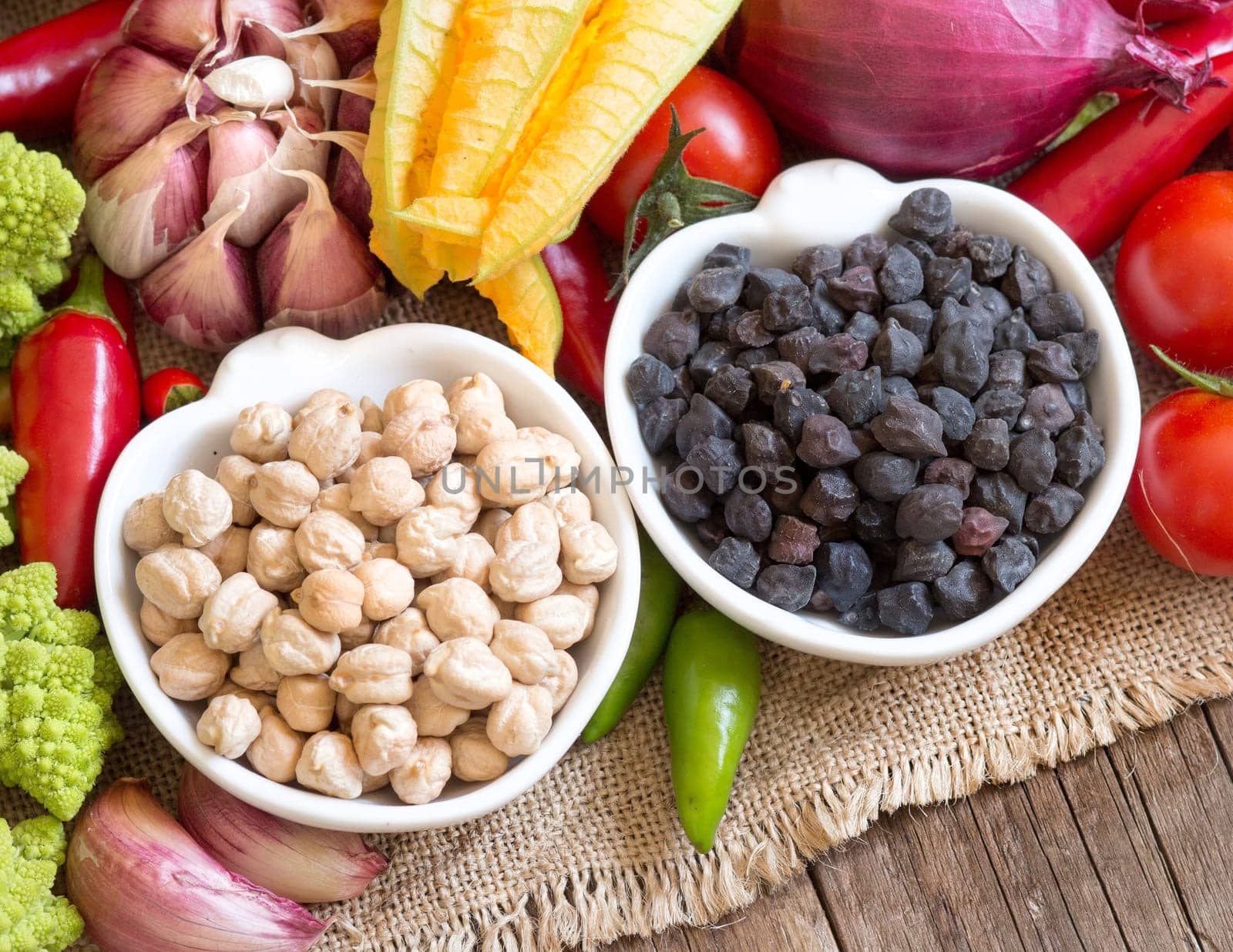 Black and white chickpea in bowls with vegetables