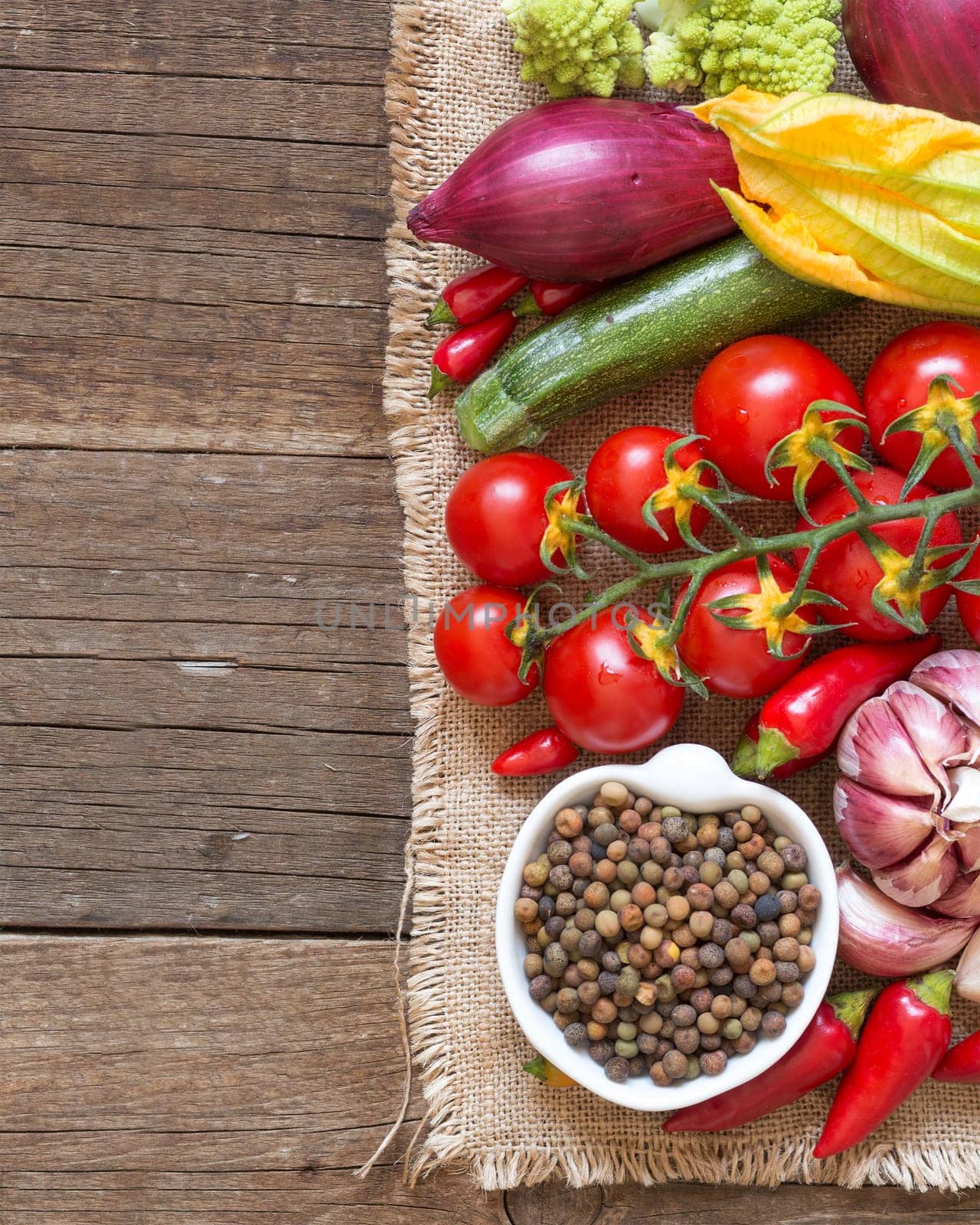 Raw organic roveja beans and vegetables on wooden table
