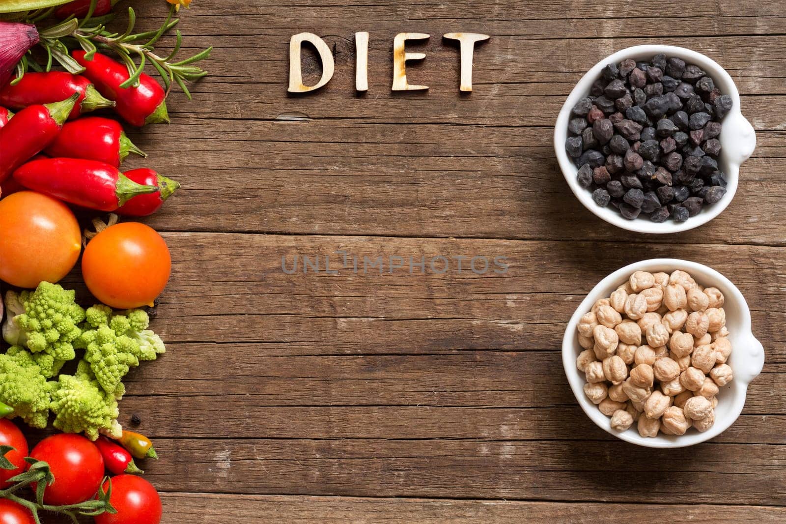 Vegetable, chickpea and word Diet on a wooden table background