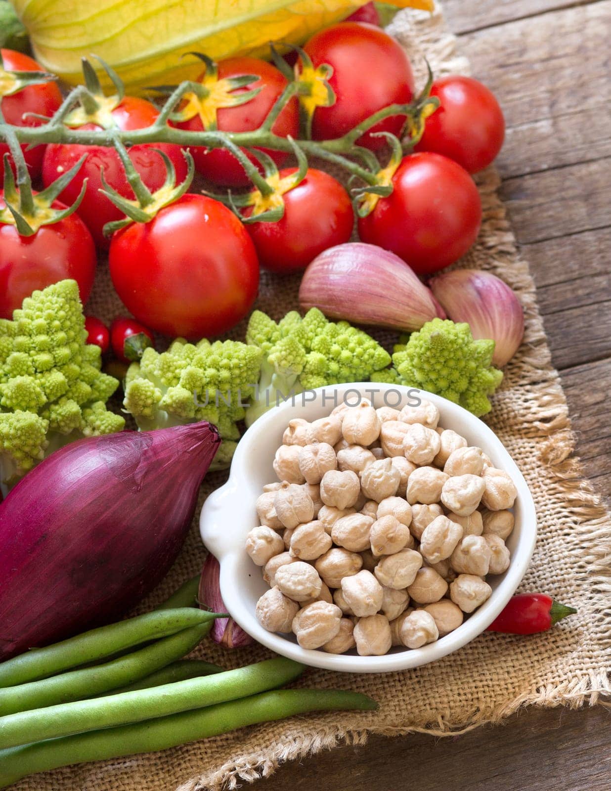 Dried organic chickpea in a bowl and vegetables